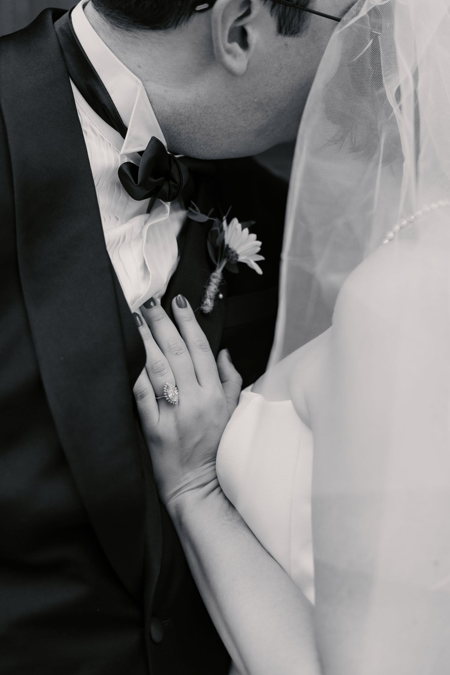 Intimate black and white wedding photos showing tender moments between newlyweds.