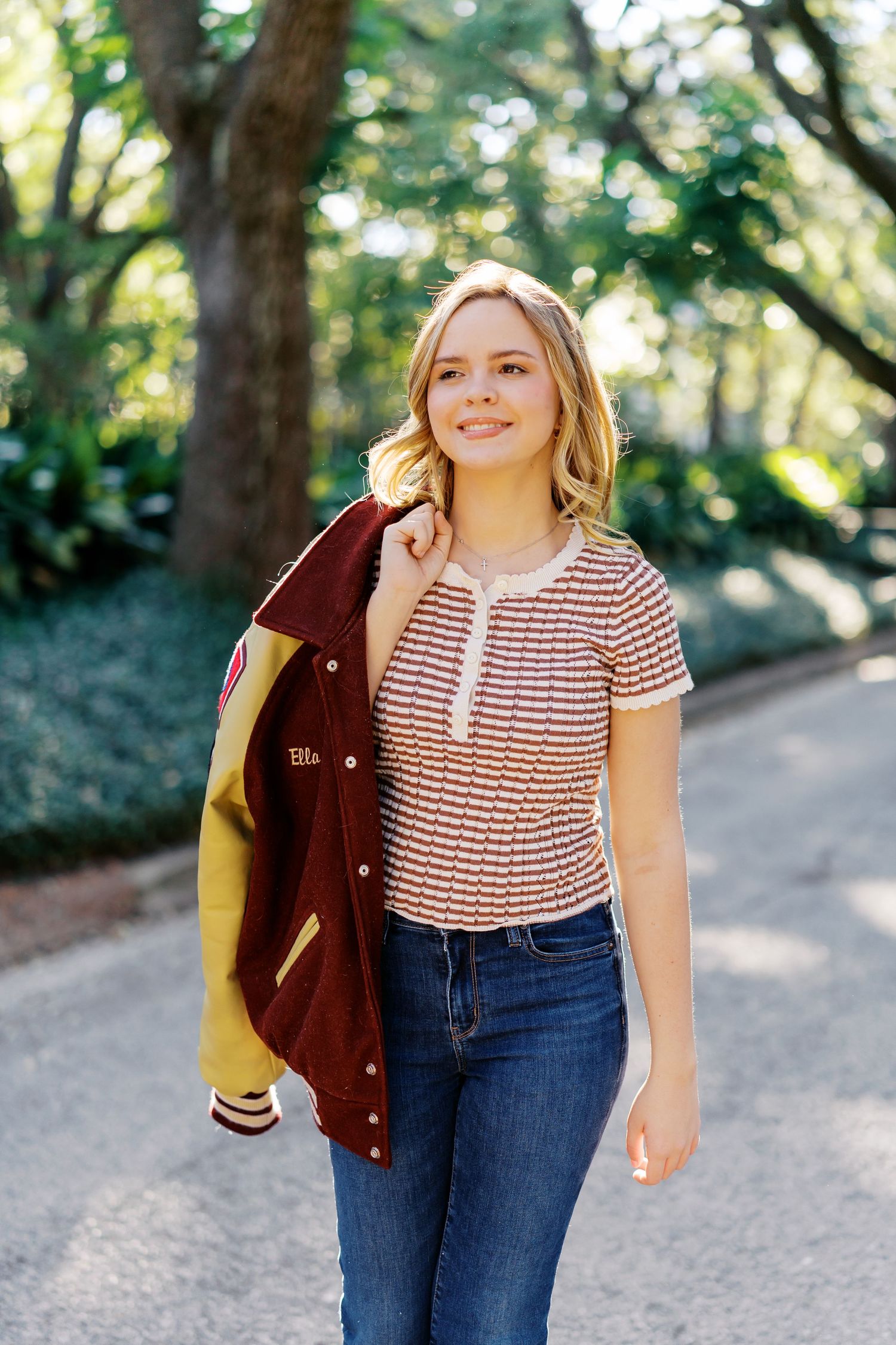Casual outdoor portraits featuring someone in a striped shirt and denim with a varsity jacket.