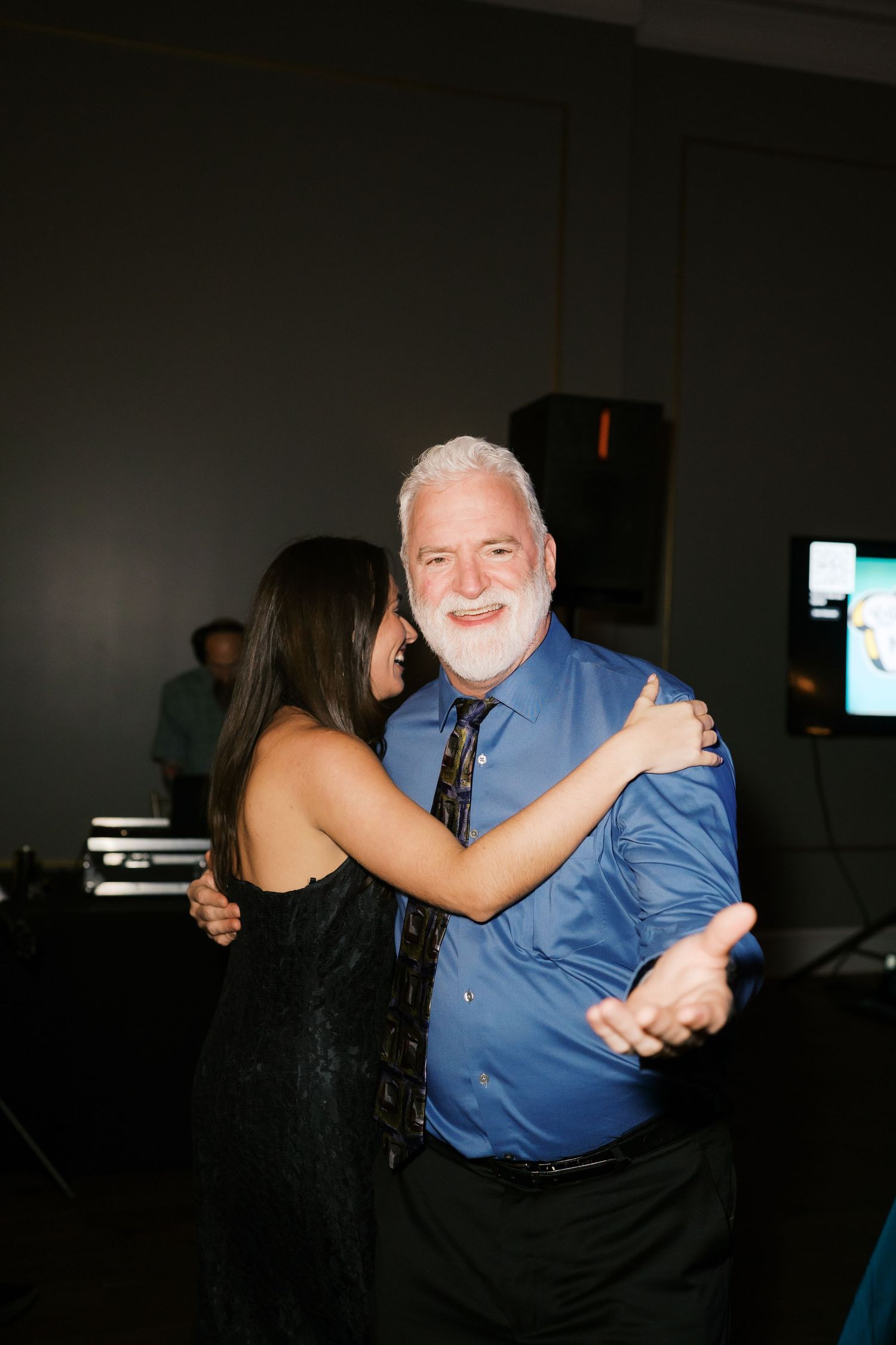 Wedding guests sharing dances during an evening reception celebration.