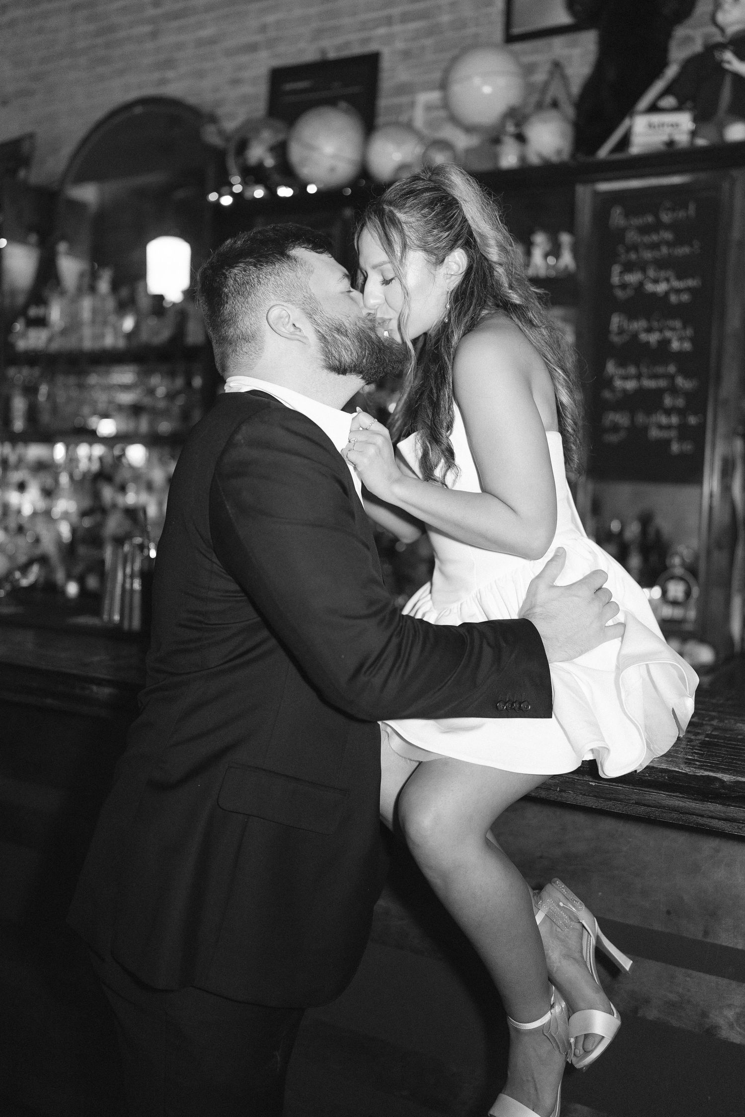 Intimate black and white photo series captured at vintage bar setting.