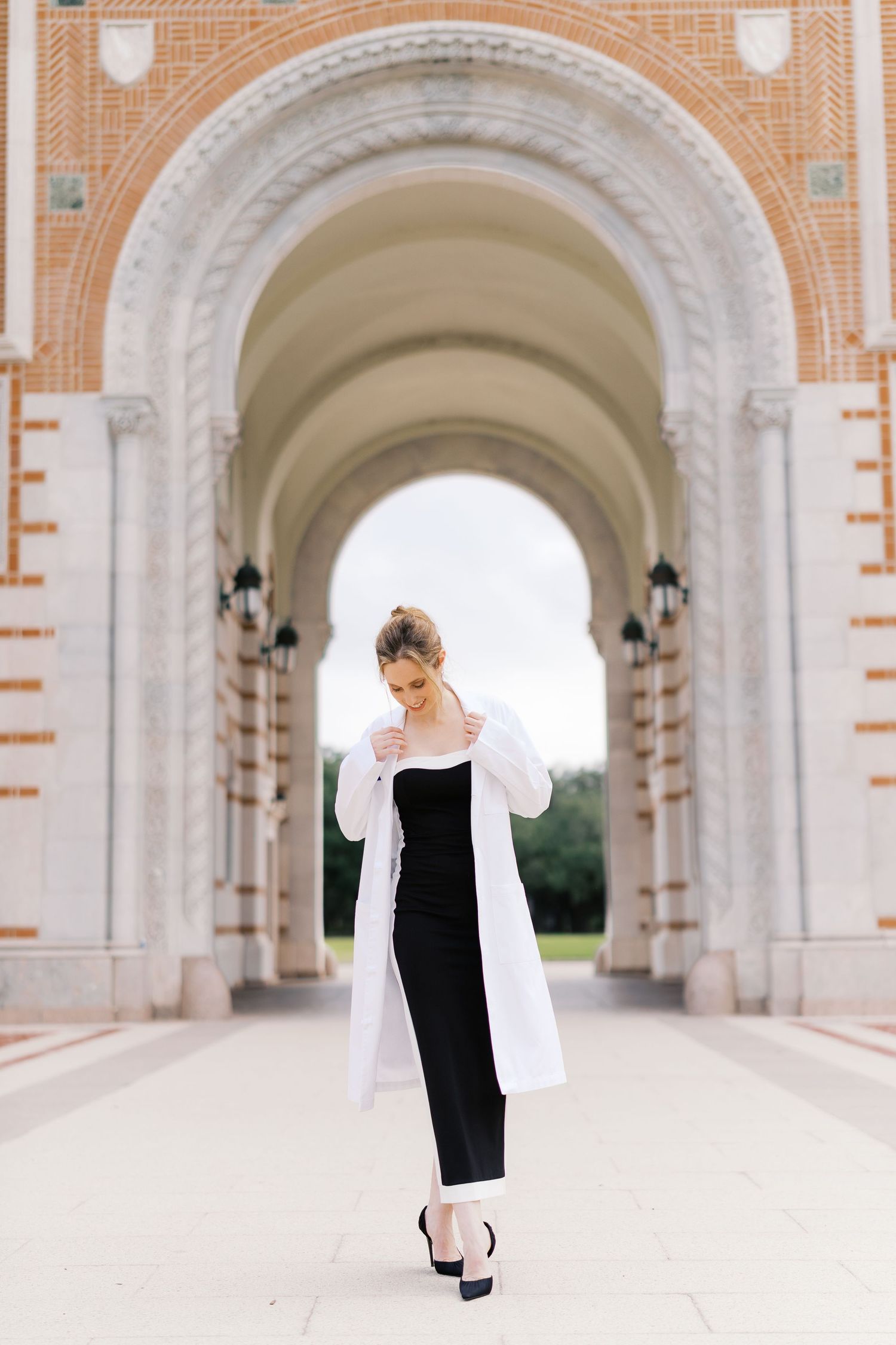 Walking poses captured under majestic arched colonnade with terracotta accents.