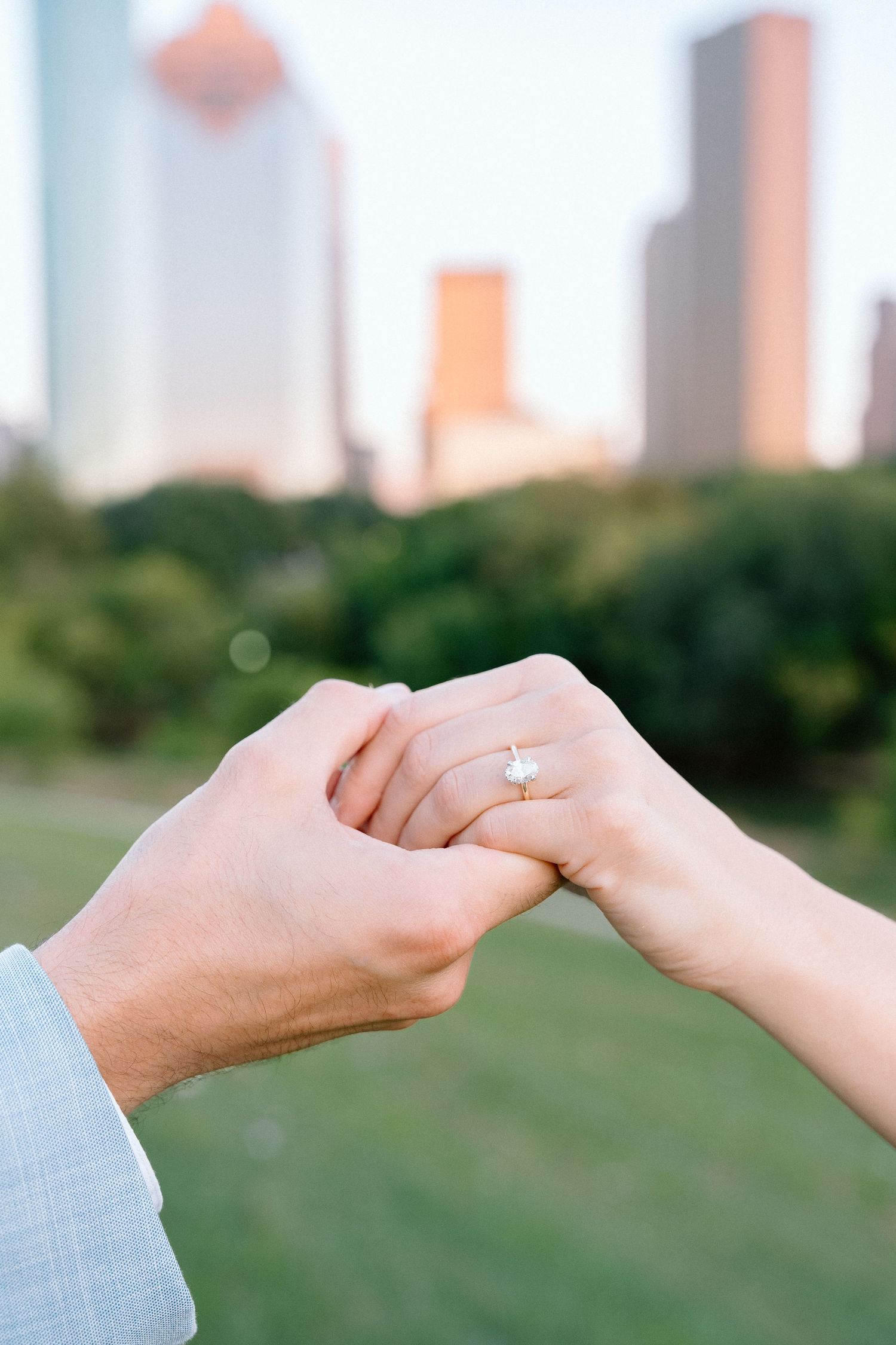 Series of close-up shots showing hands exchanging an engagement ring with city skyline in background.