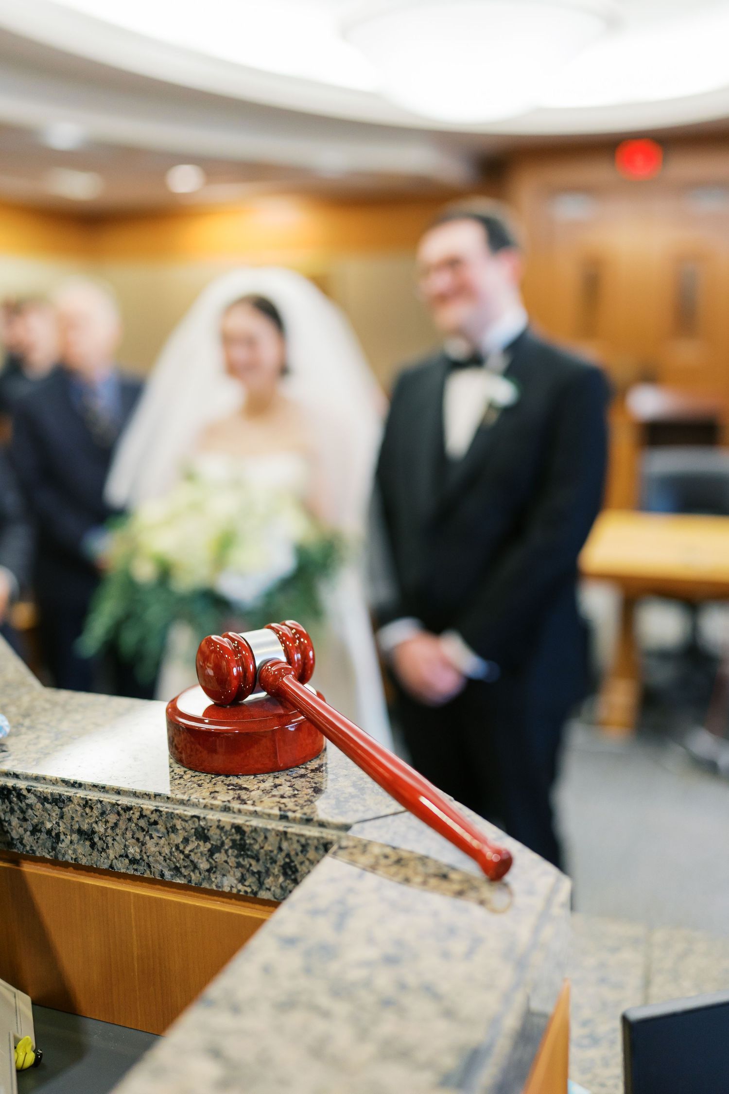 Judge's gavel rests on marble counter during courthouse wedding ceremony.