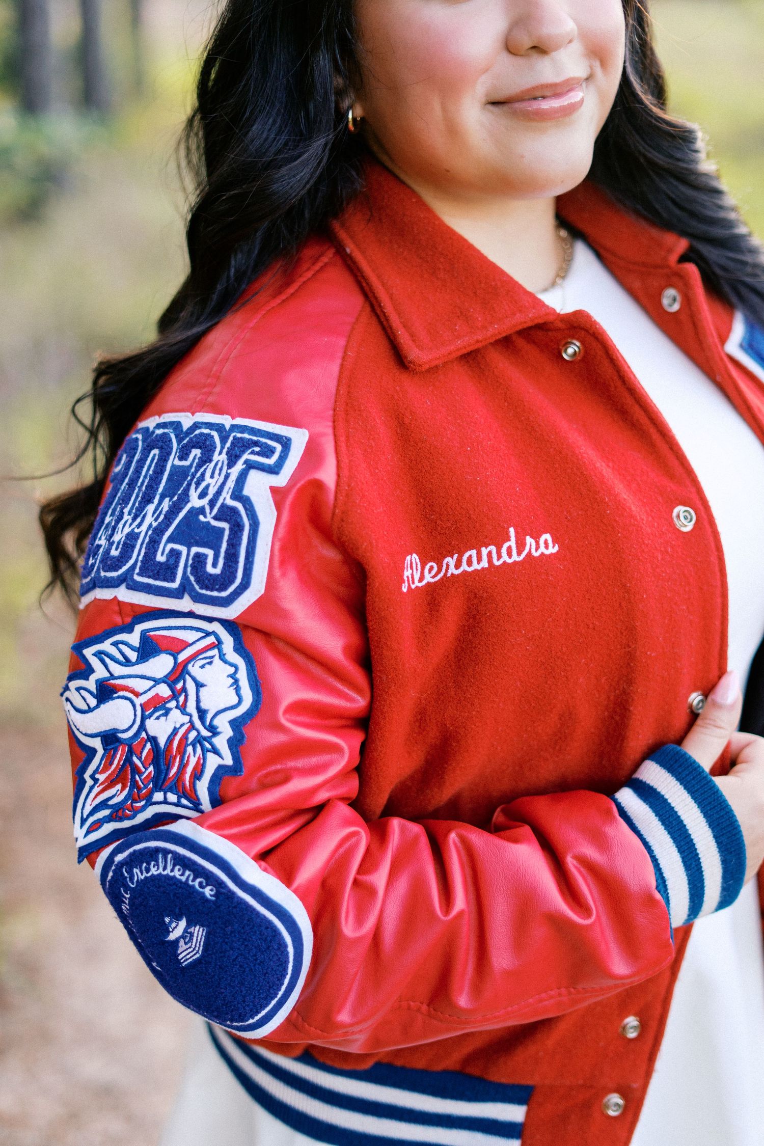 Close-up shots of a red and blue varsity letter jacket with embroidered details.