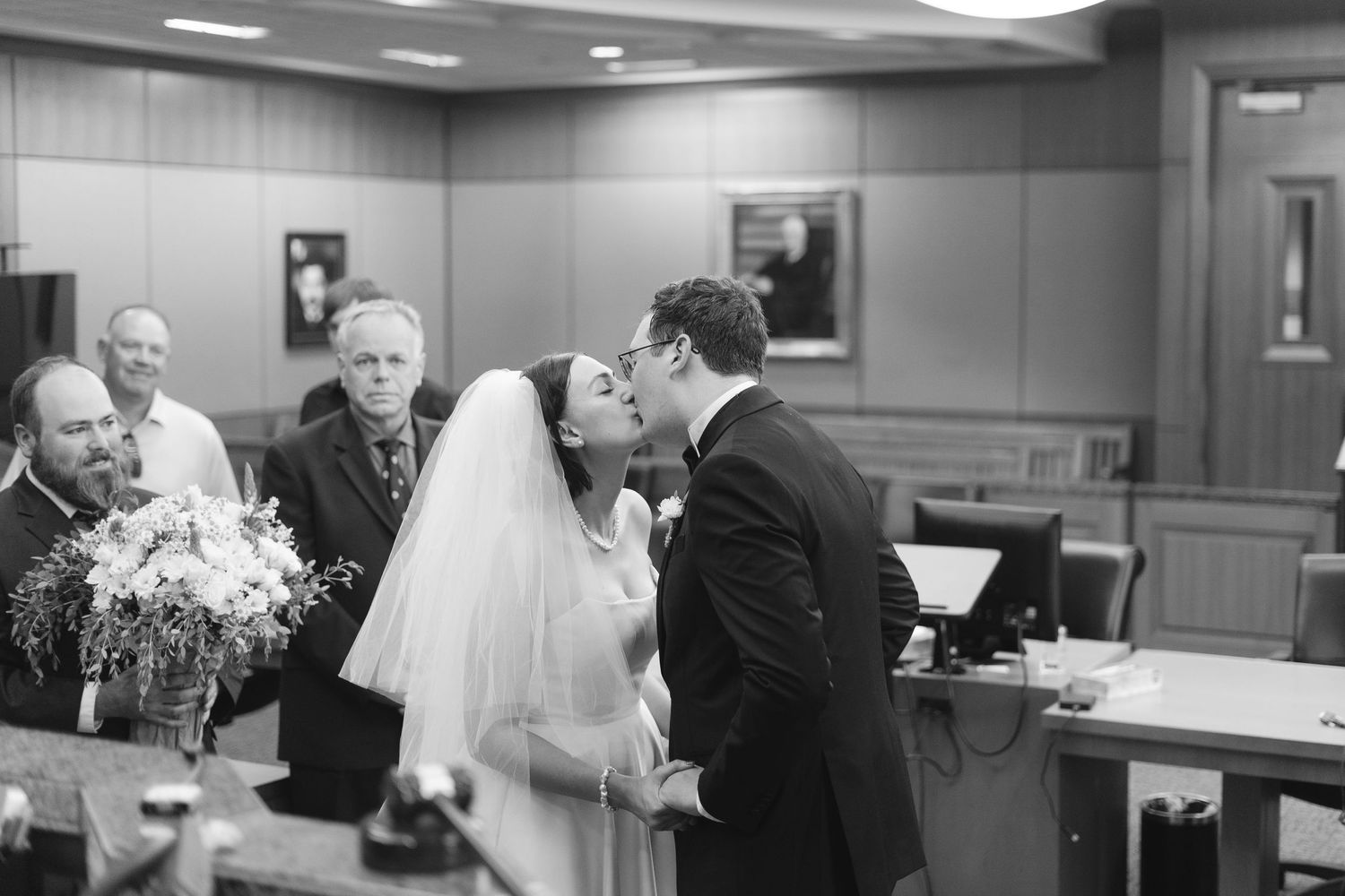 Wedding ceremony moments captured inside a government building hallway.