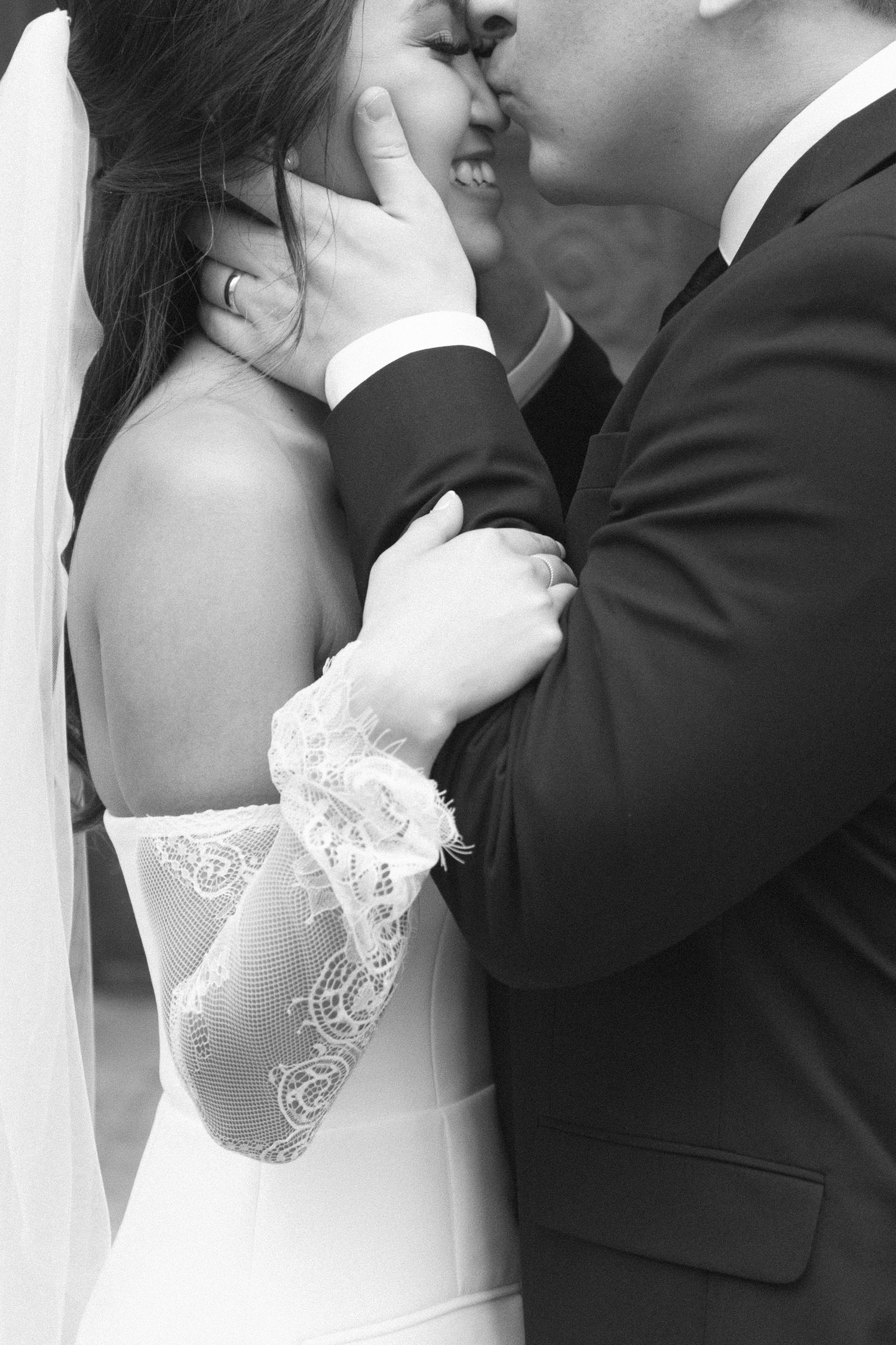 Close-up of wedding couple sharing romantic moment in formal attire.