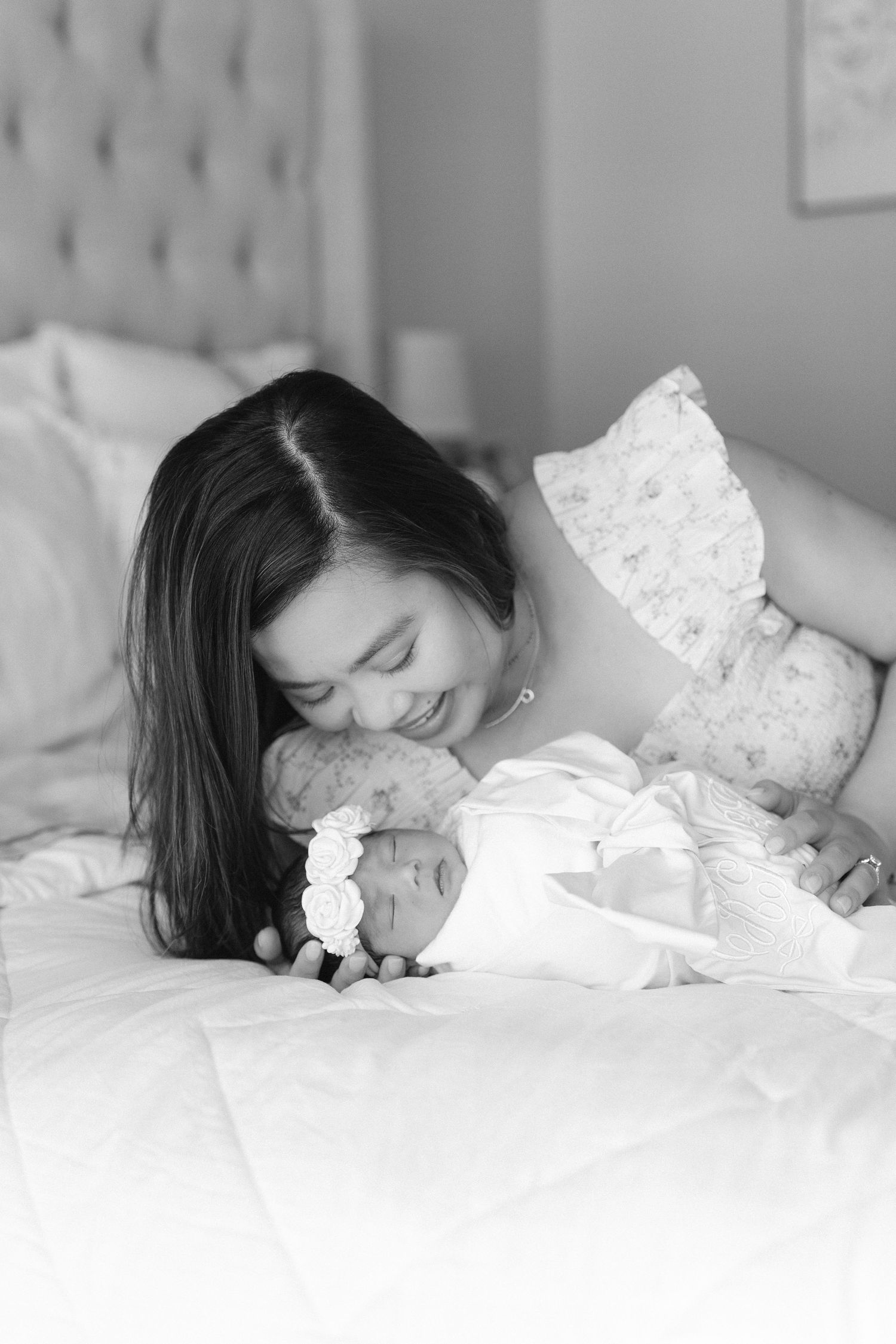 A series of black and white photos showing a person lying on white bedding in a relaxed pose.