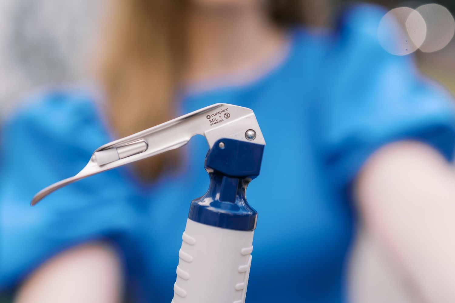 Close-up detail shots of medical devices against blue fabric.