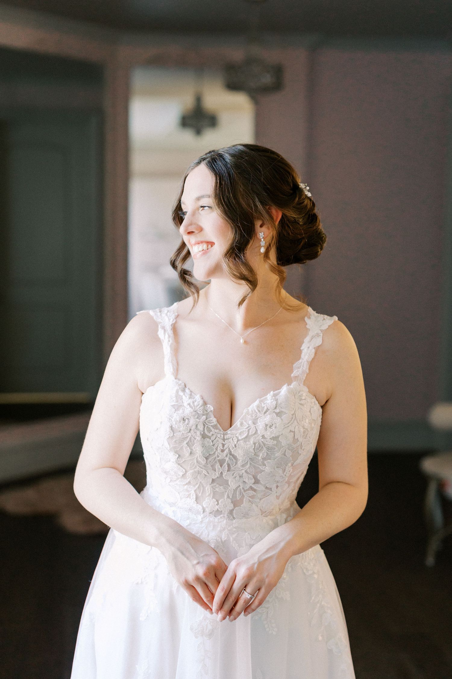 Close-up details of a beautiful white lace wedding dress bodice.