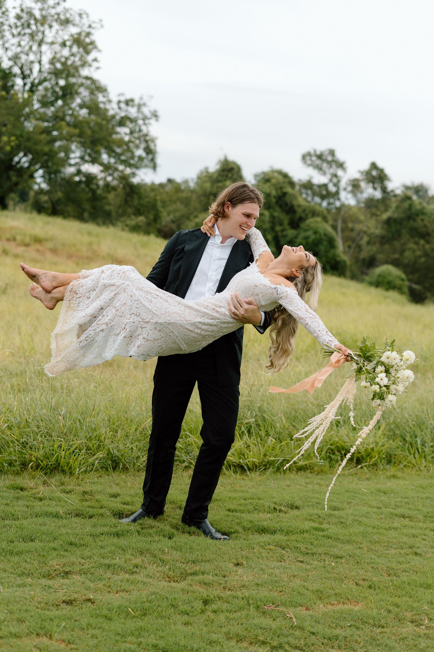 Playful wedding photo sequence showing a couple performing a dramatic dip pose in a grassy field.