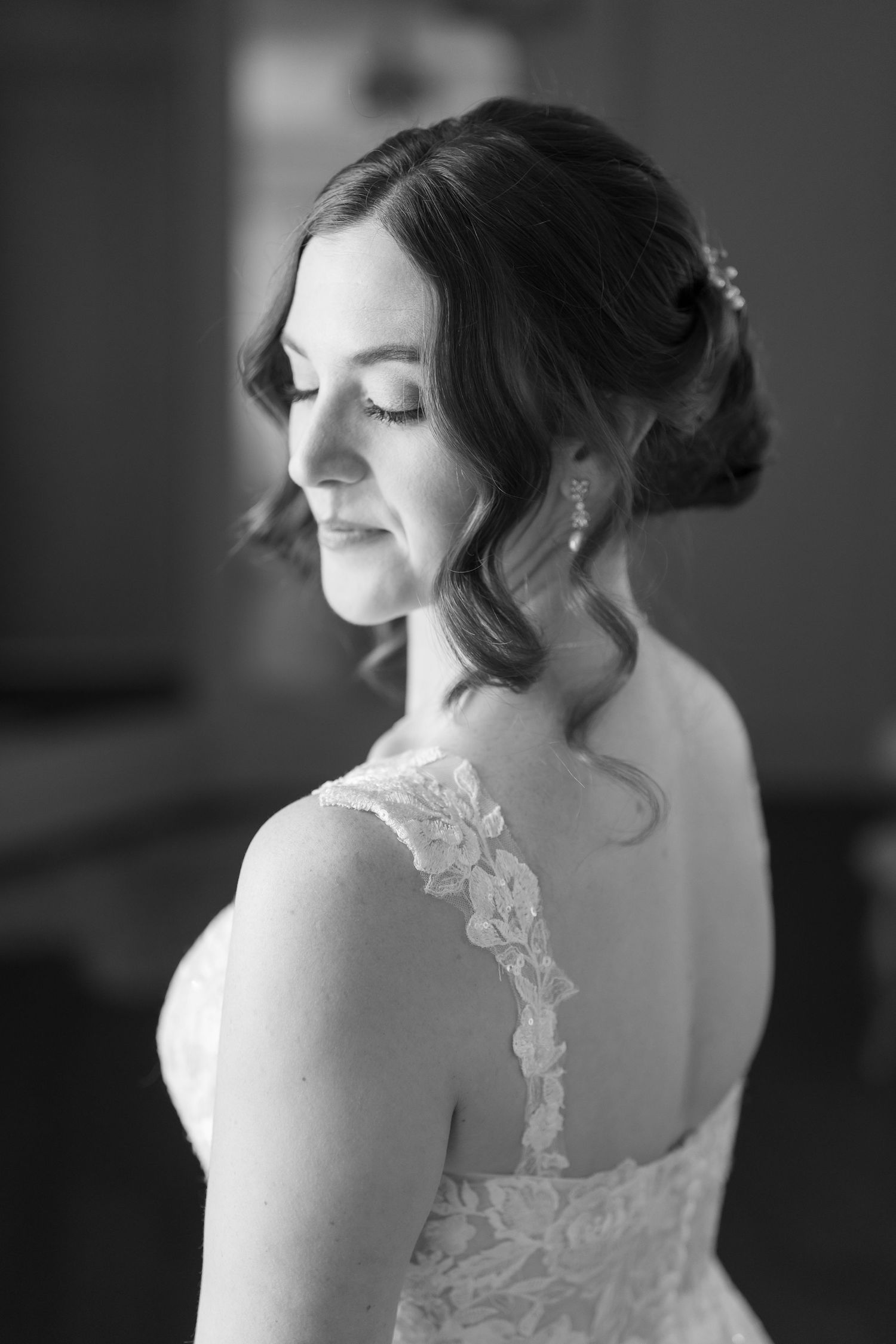 Artistic black and white portraits showing the lace details of a wedding dress.