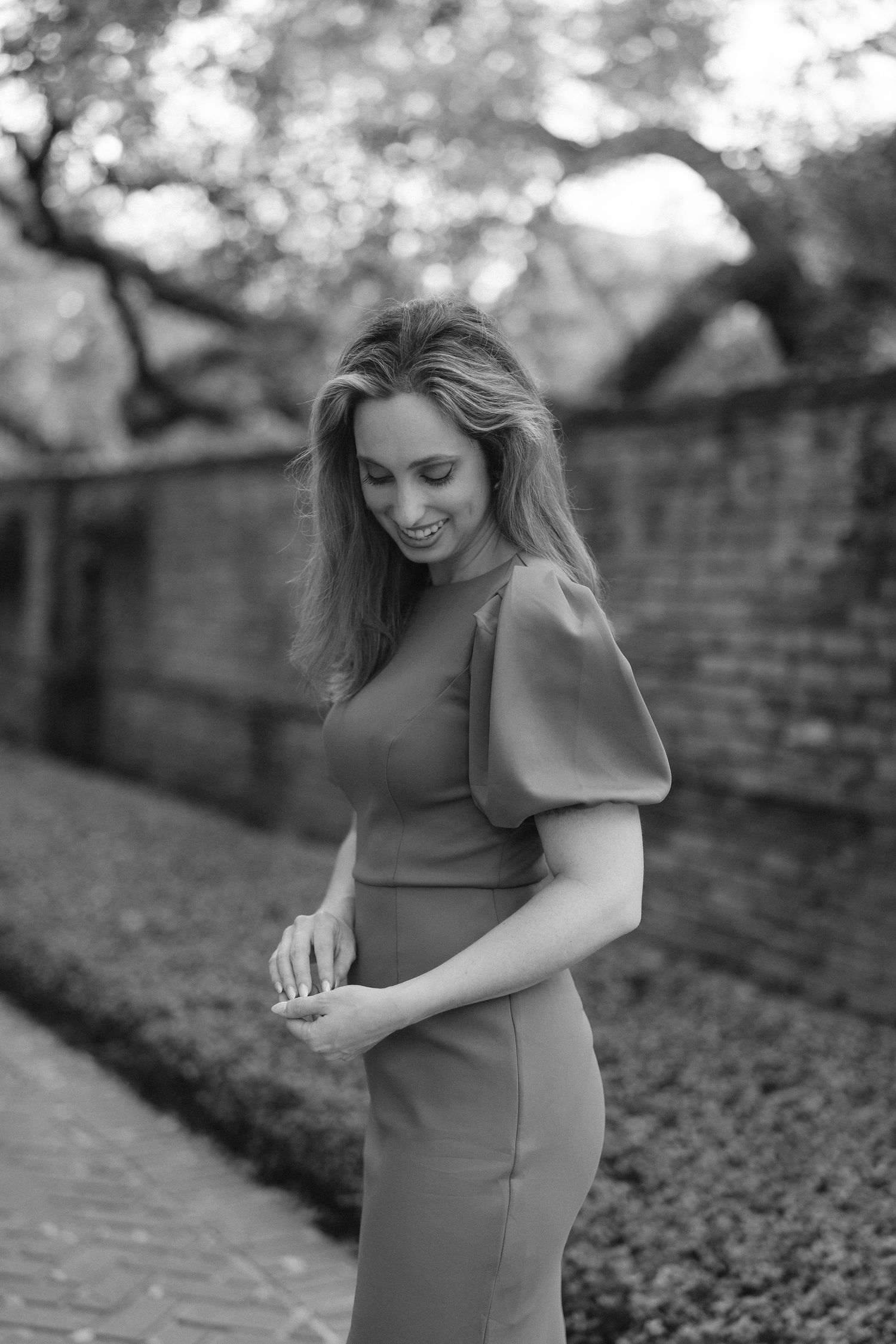 Black and white portrait capturing candid moments of joy in an outdoor garden setting.