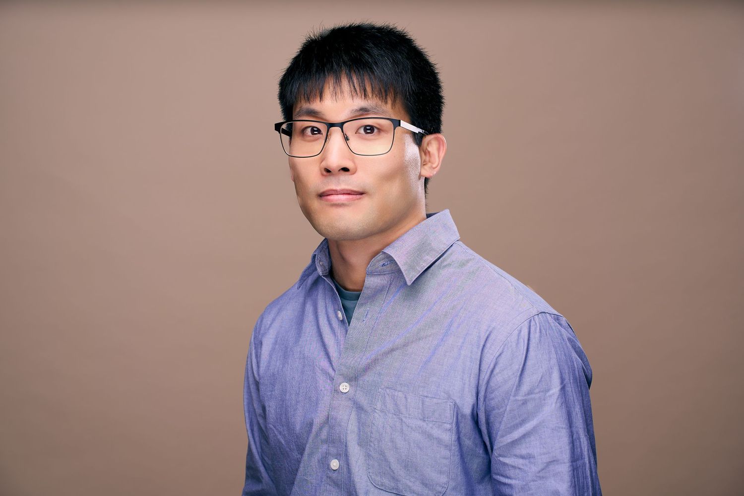 Professional headshot photos in a series showing different angles and expressions against a neutral background.
