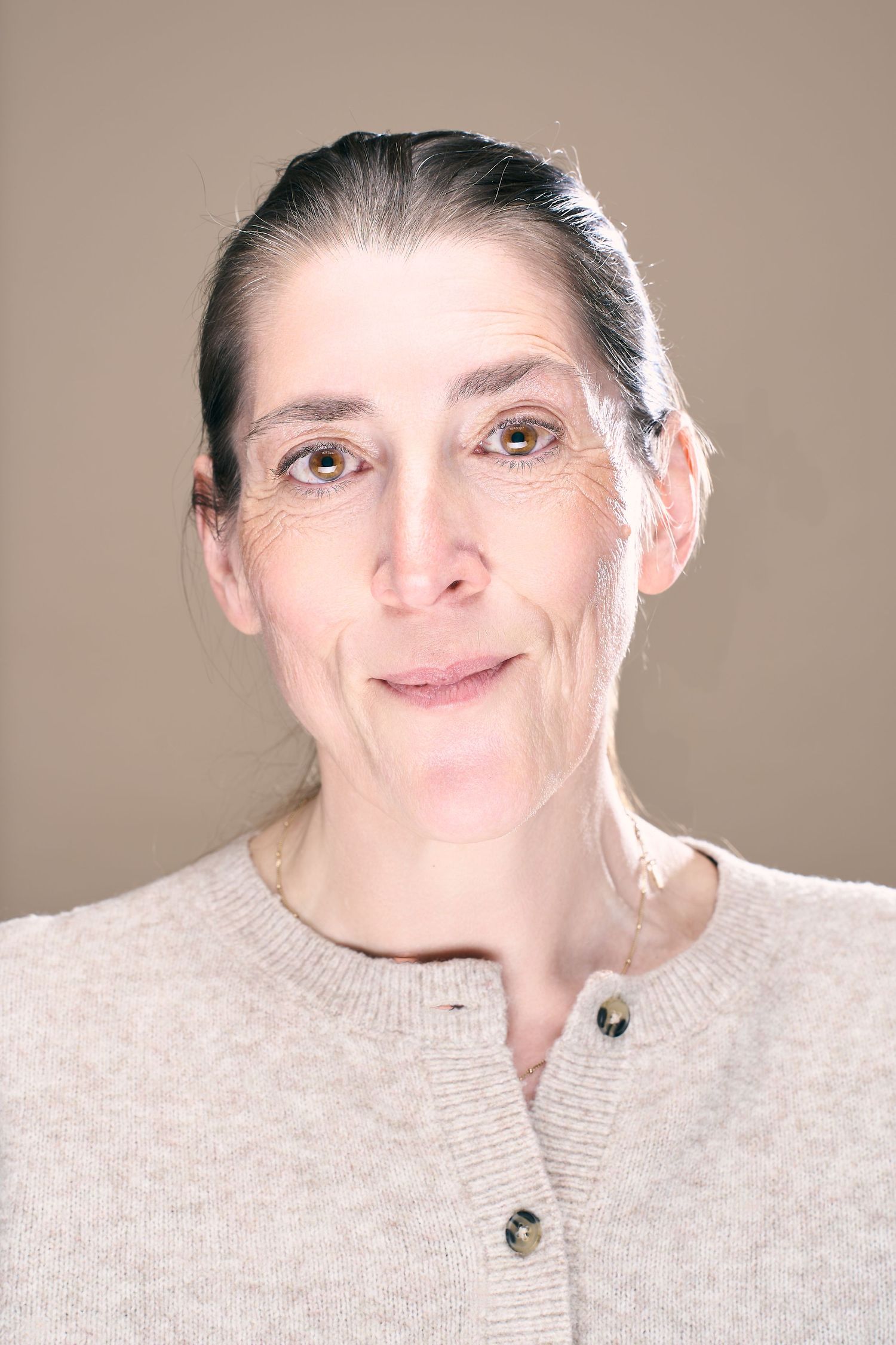 A sequence of facial expressions showing different emotions and reactions in a beige sweater against a neutral background.