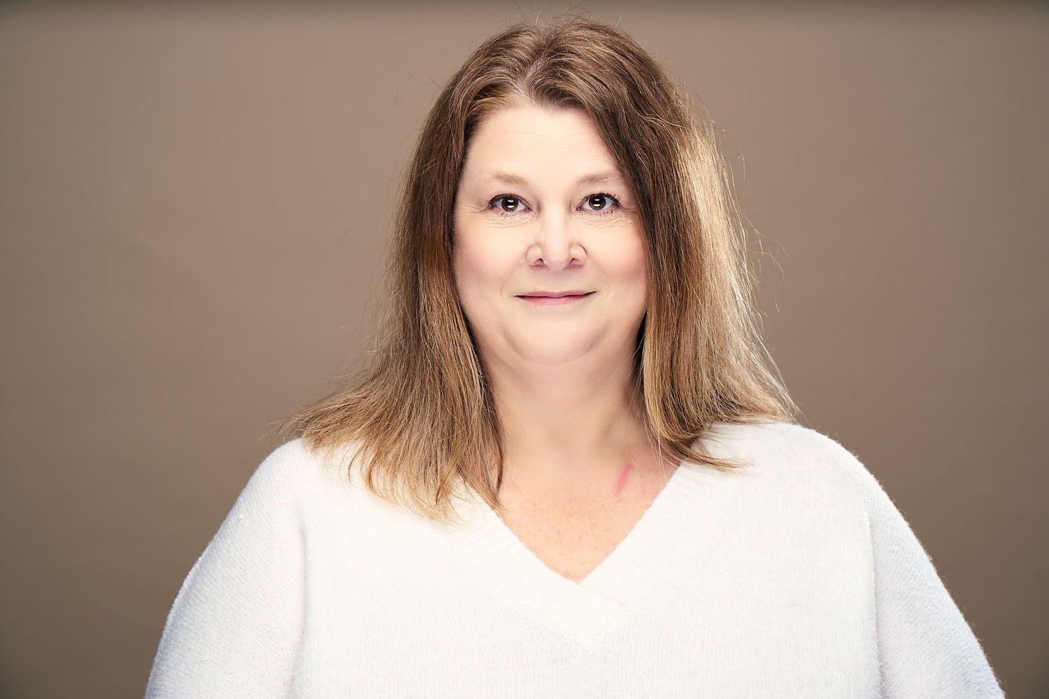 A series of headshots showing someone in a white top against a neutral background with varying expressions and poses.