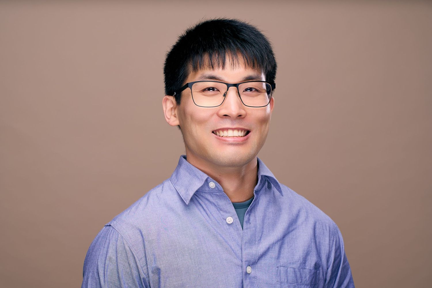 Professional headshot series showing someone in a light blue button-down shirt against a neutral background.