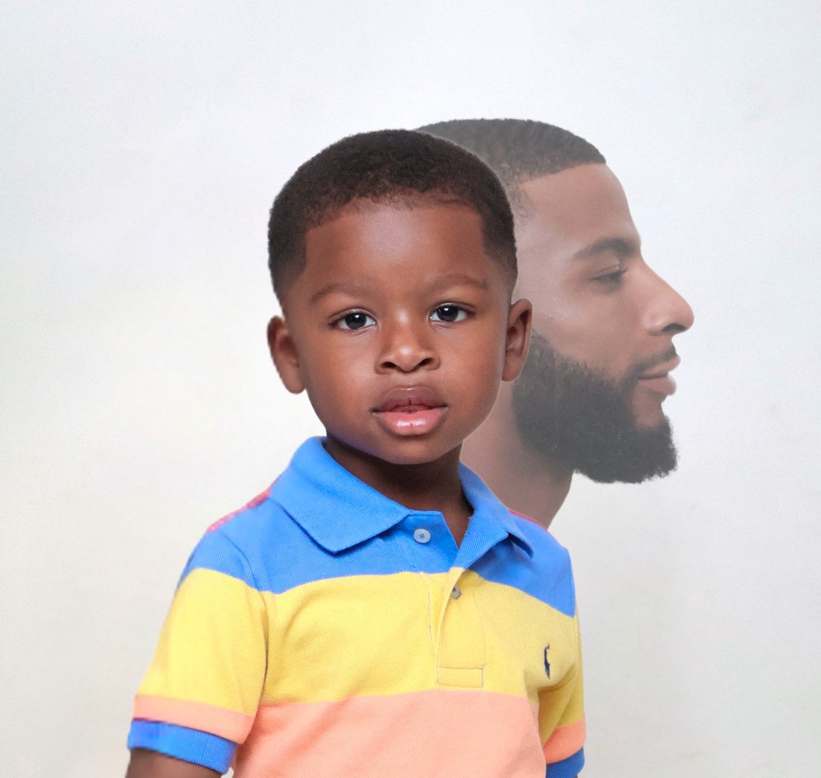 Young boy in colorful striped polo shirt with a faded silhouette of a bearded man behind him.
