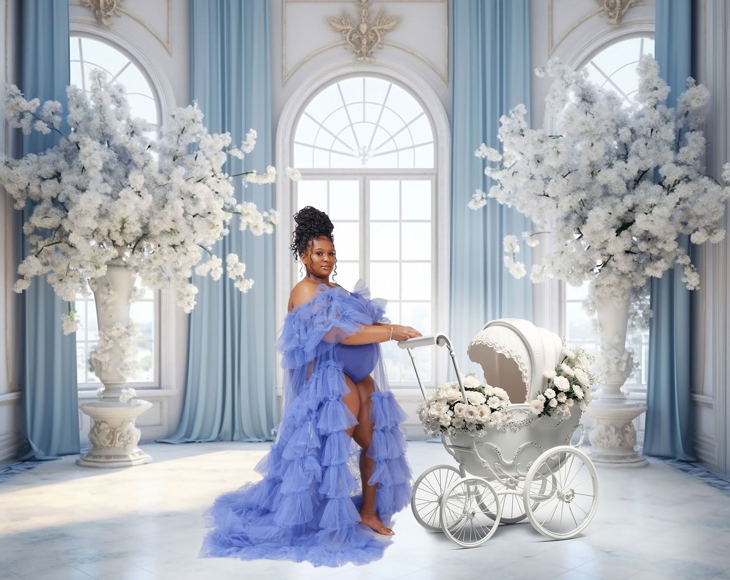 Pregnant woman in blue ruffled gown poses with vintage white baby carriage amid white floral arrangements.
