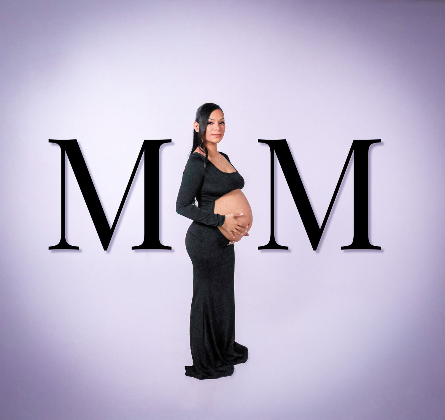 Maternity photo of woman in black dress standing between MOM letters on light purple background.