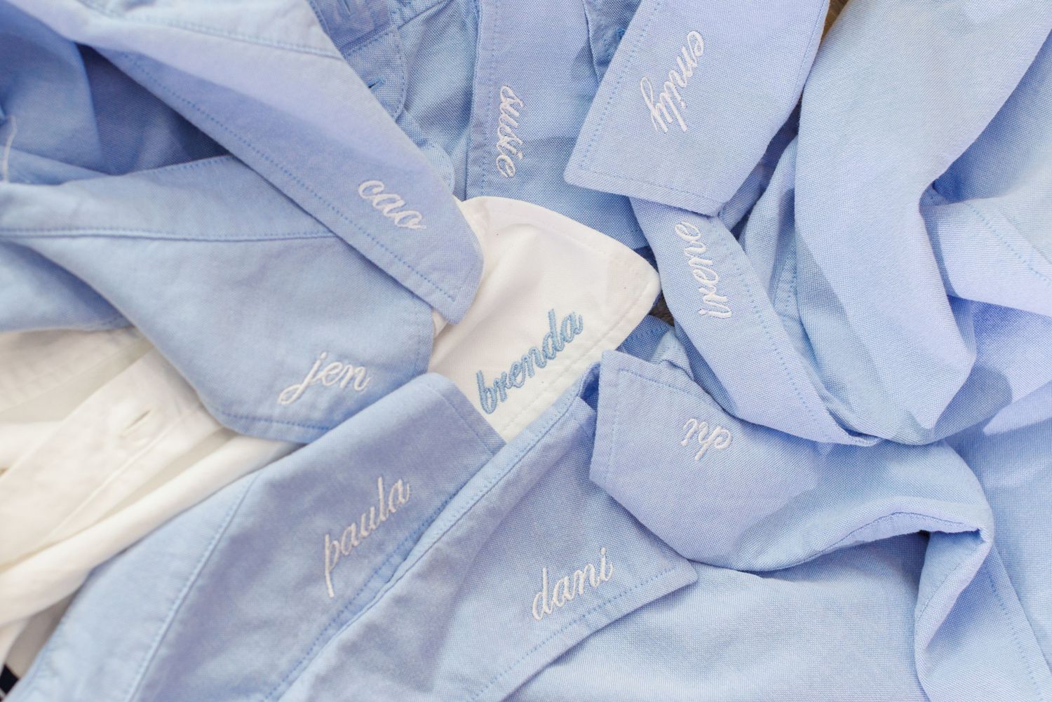 Personalized light blue and white embroidered robes with custom names, perfect for bridesmaids or special occasions.