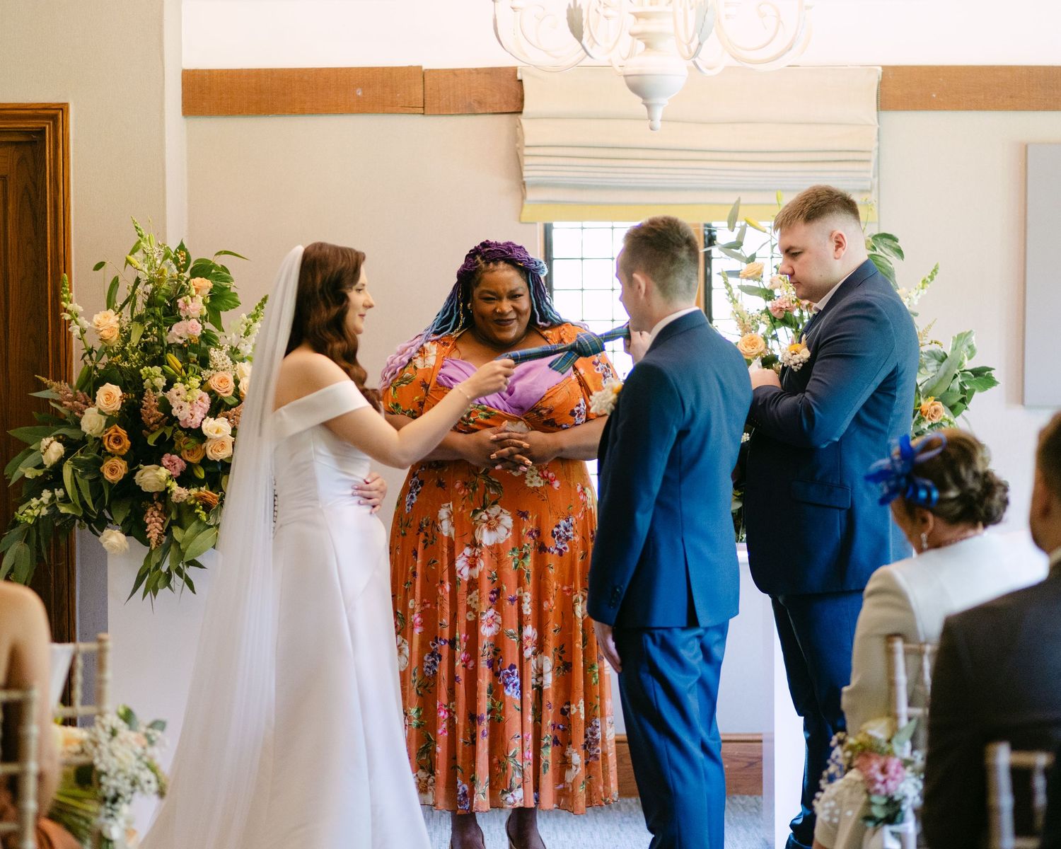 Wedding ceremony moments captured with decorative floral arrangements and lanterns along the aisle.