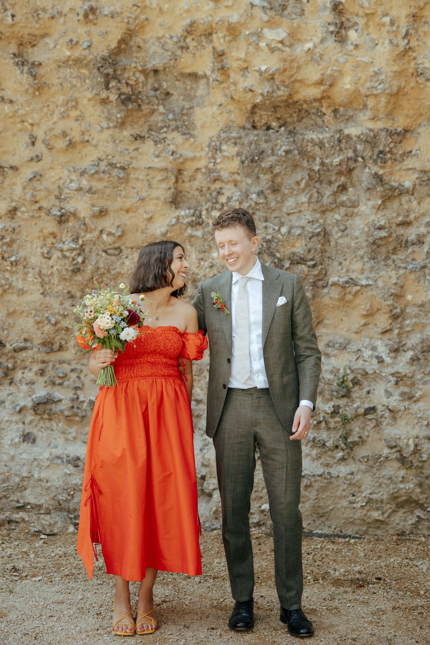 Newlyweds smiling and holding hands by the river near London Street Brasserie in Reading