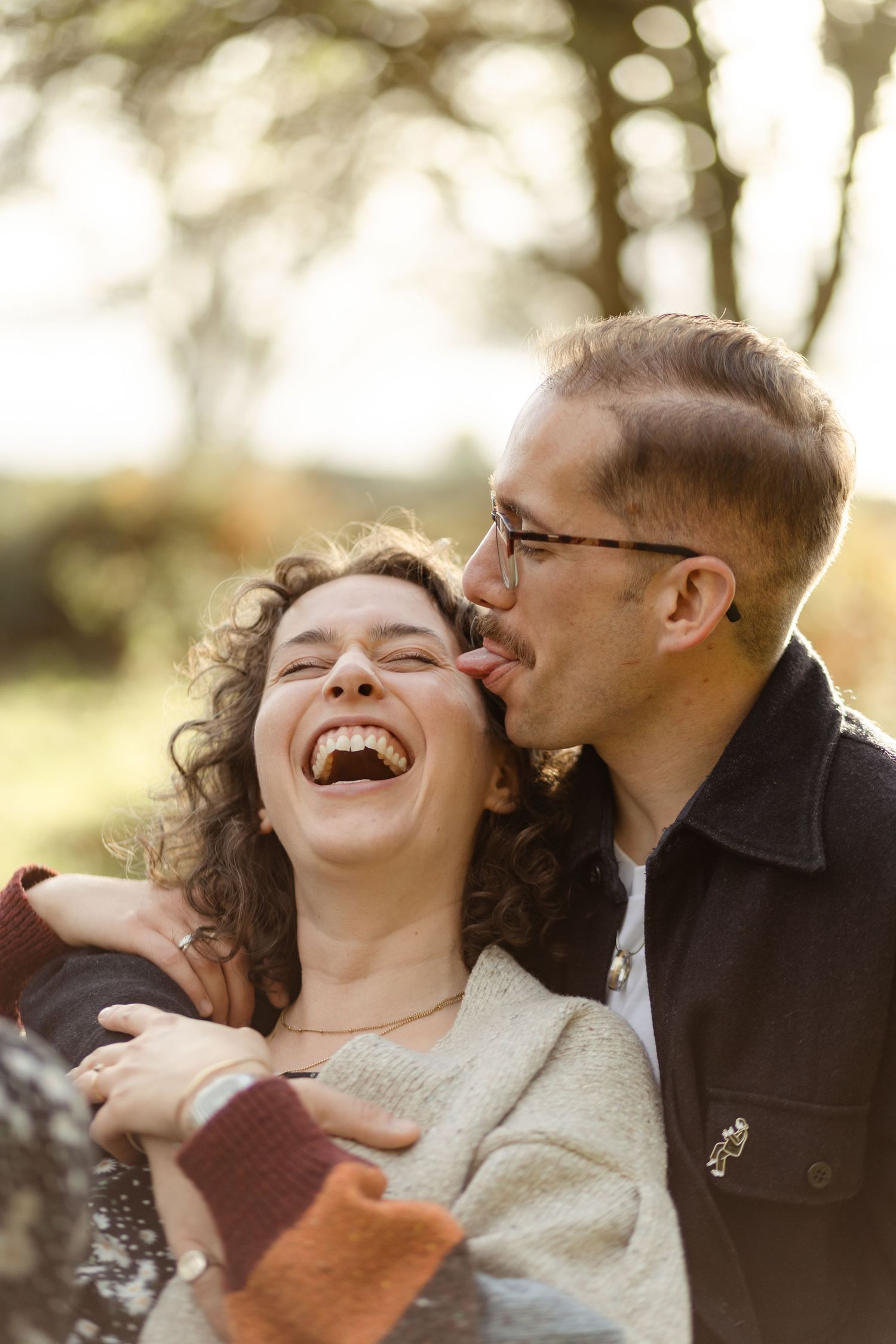 Joyful laughter captured during an outdoor couples photography session.