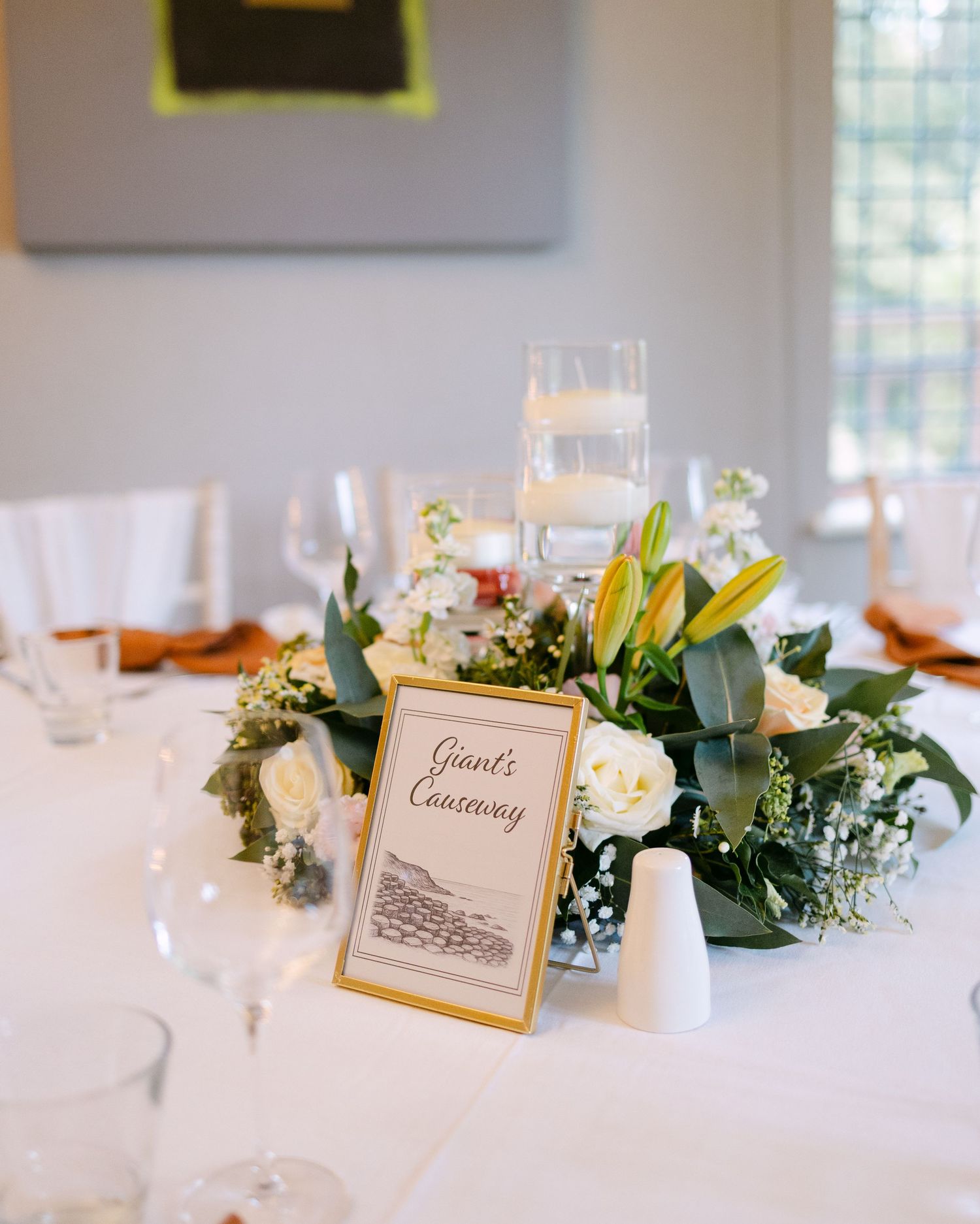 Elegant wedding reception table with floral centerpieces and place cards.