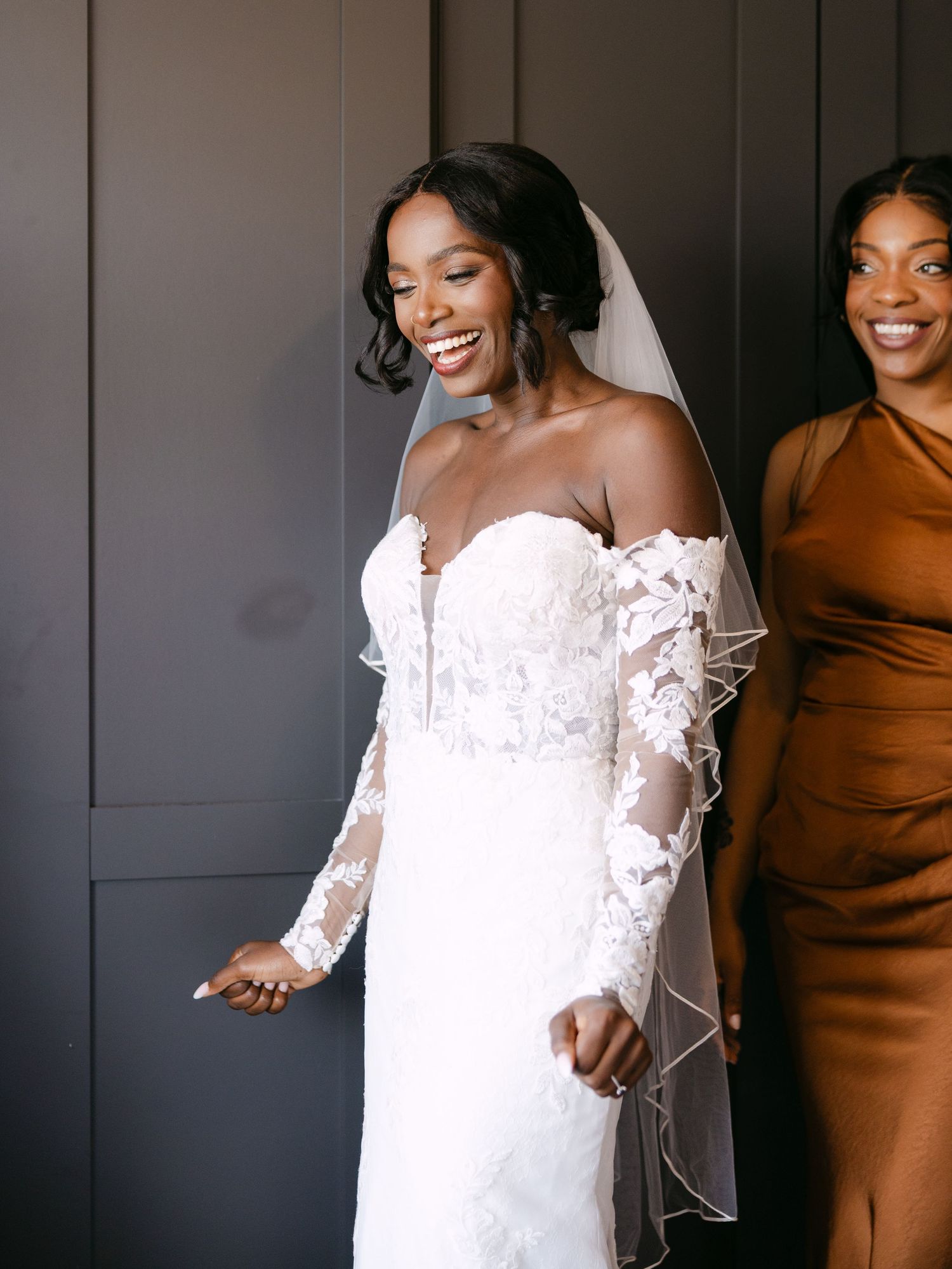 Candid moment of joy captured during wedding preparations.