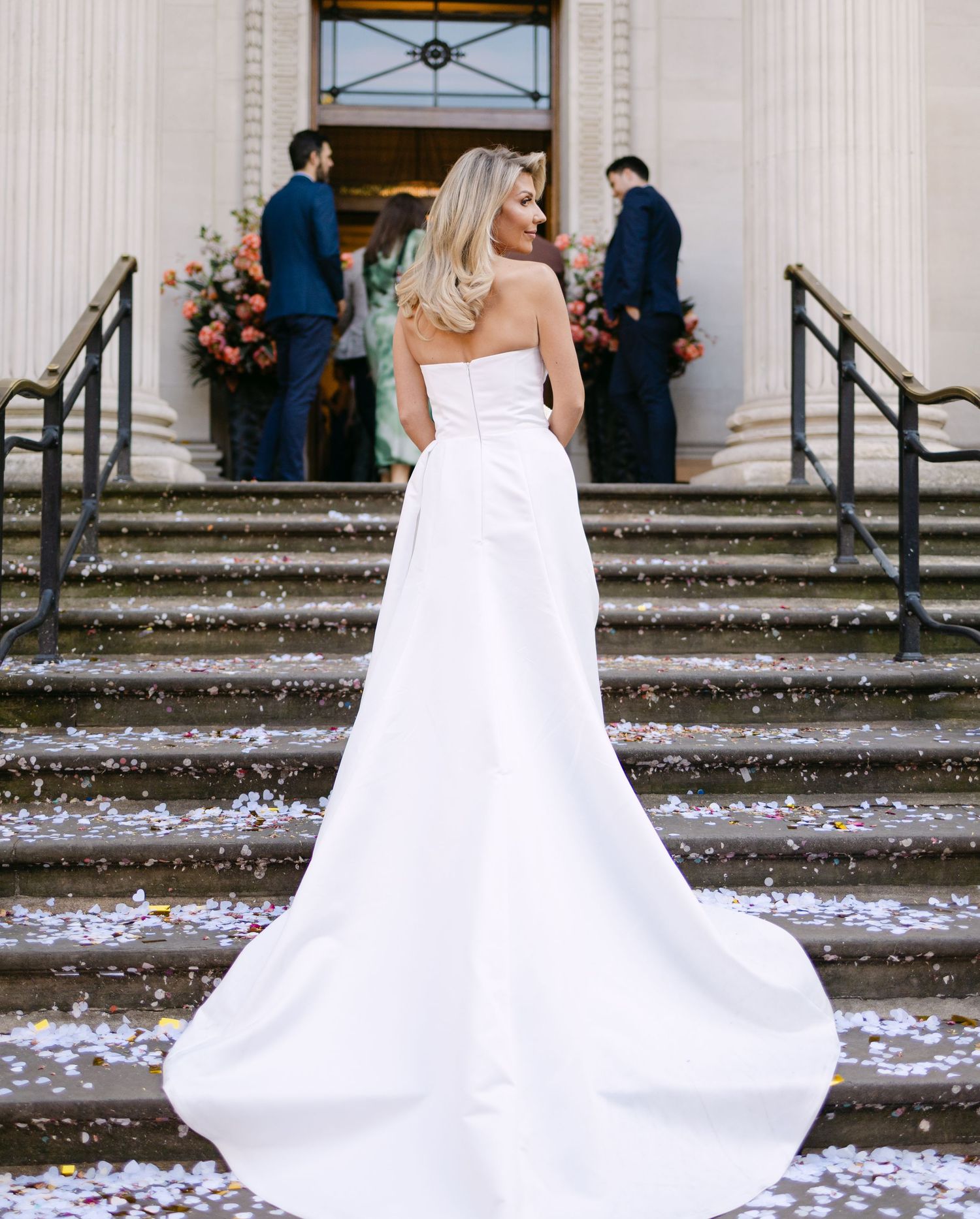 A bride and her dress train on the steps of Old Marylebone Town Hall