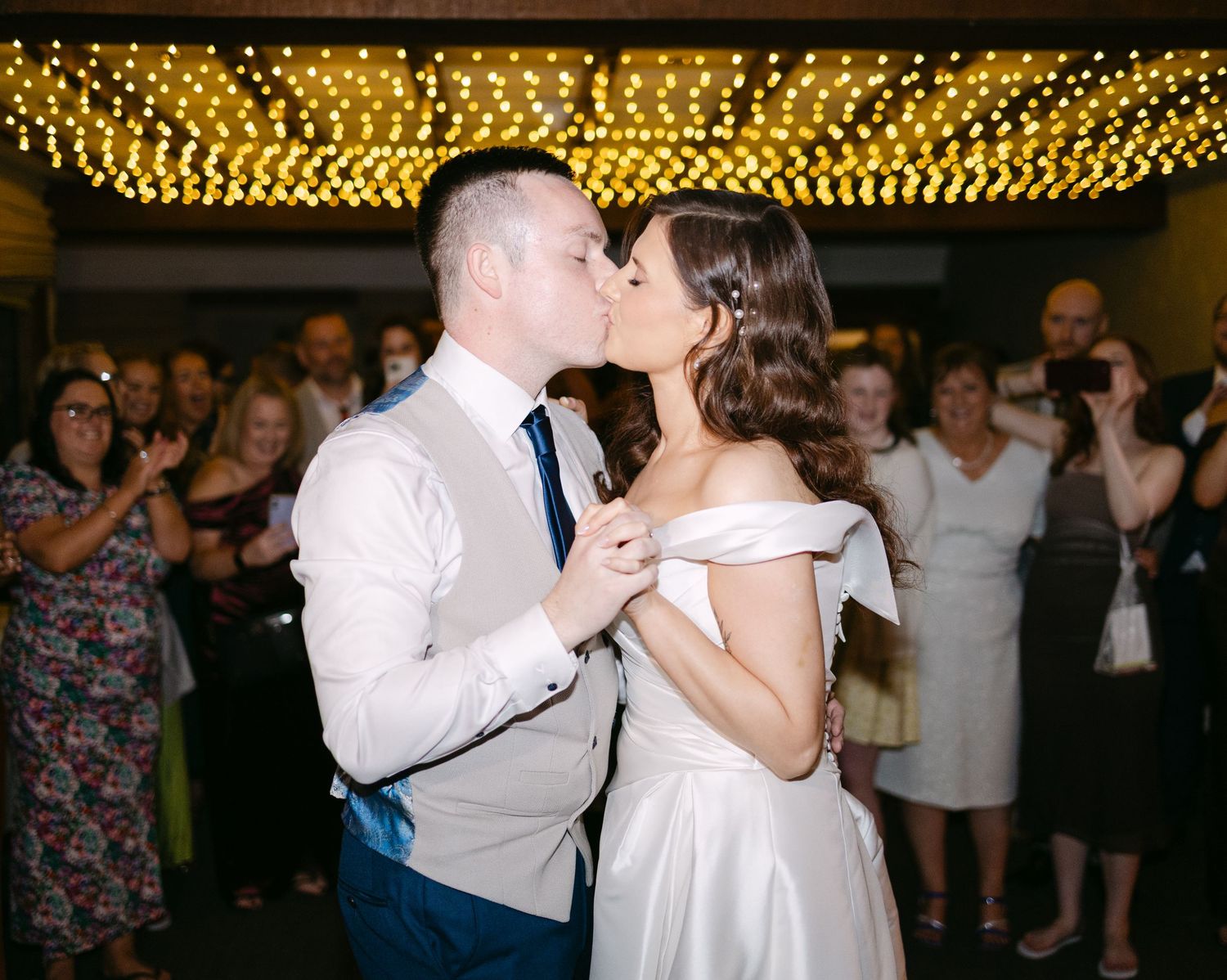 Wedding reception dance under warm string lights.