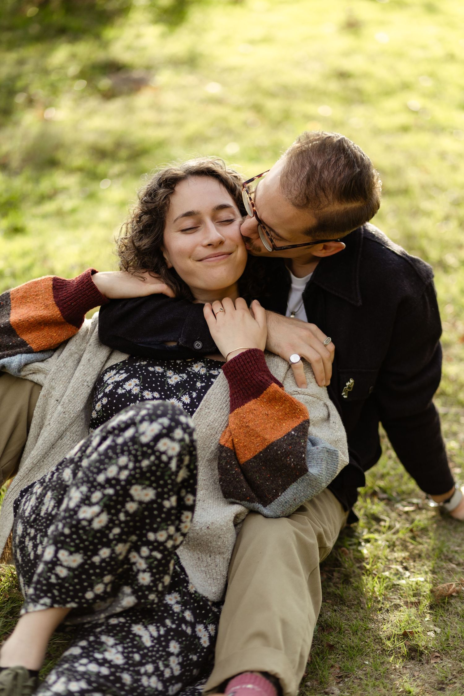 Candid moments captured during a romantic outdoor photoshoot.