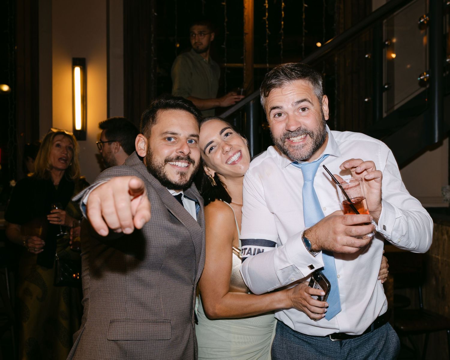 Wedding guests share laughs and drinks during the reception celebration.