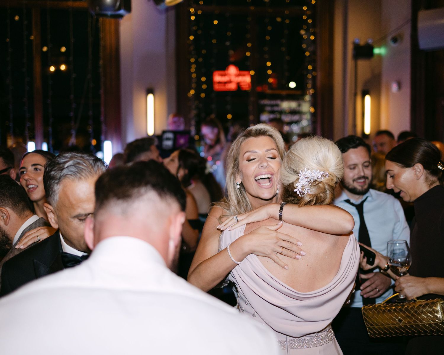 Bride embraces her mum with joy on the dancefloor at a London wedding at the Balfour