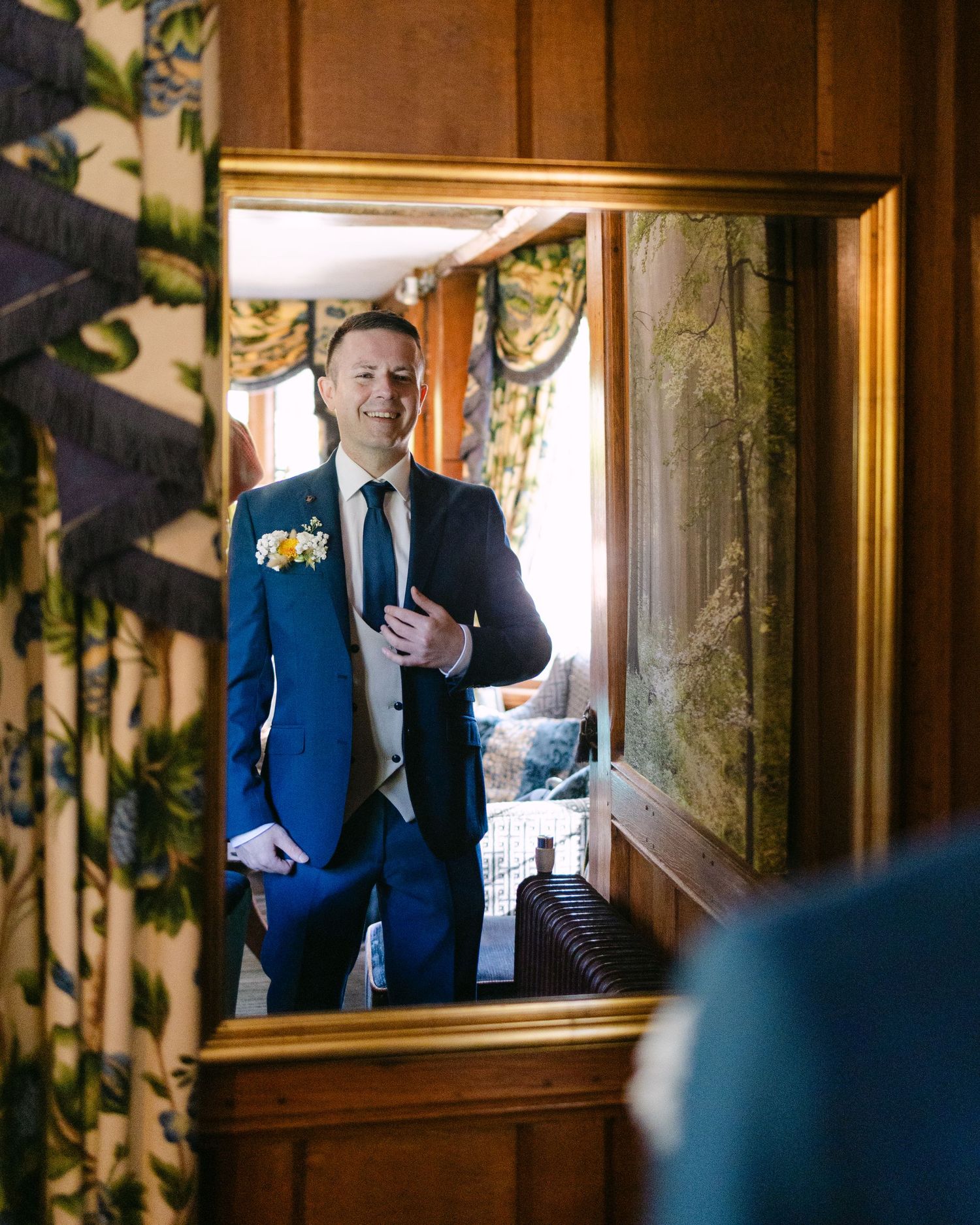 A series of photos showing a person in a navy blue suit looking through a wooden-framed window.