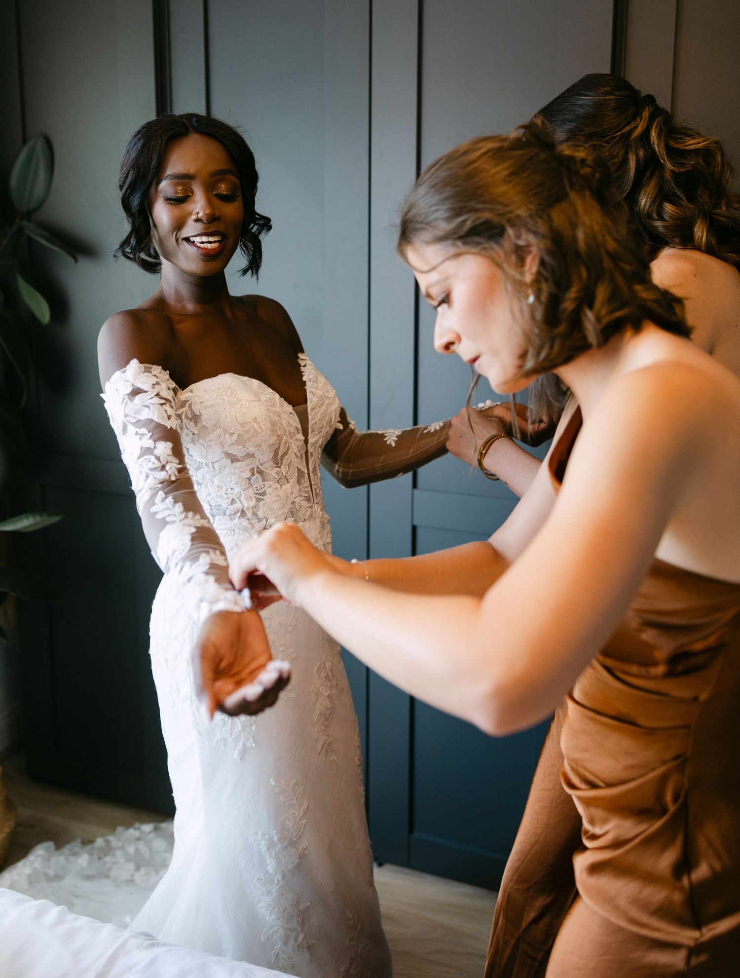 A touching moment of preparation in a wedding dress with elegant lace details.