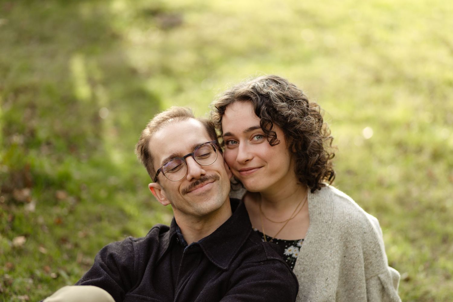 Intimate outdoor portrait session in natural lighting with soft bokeh effects.