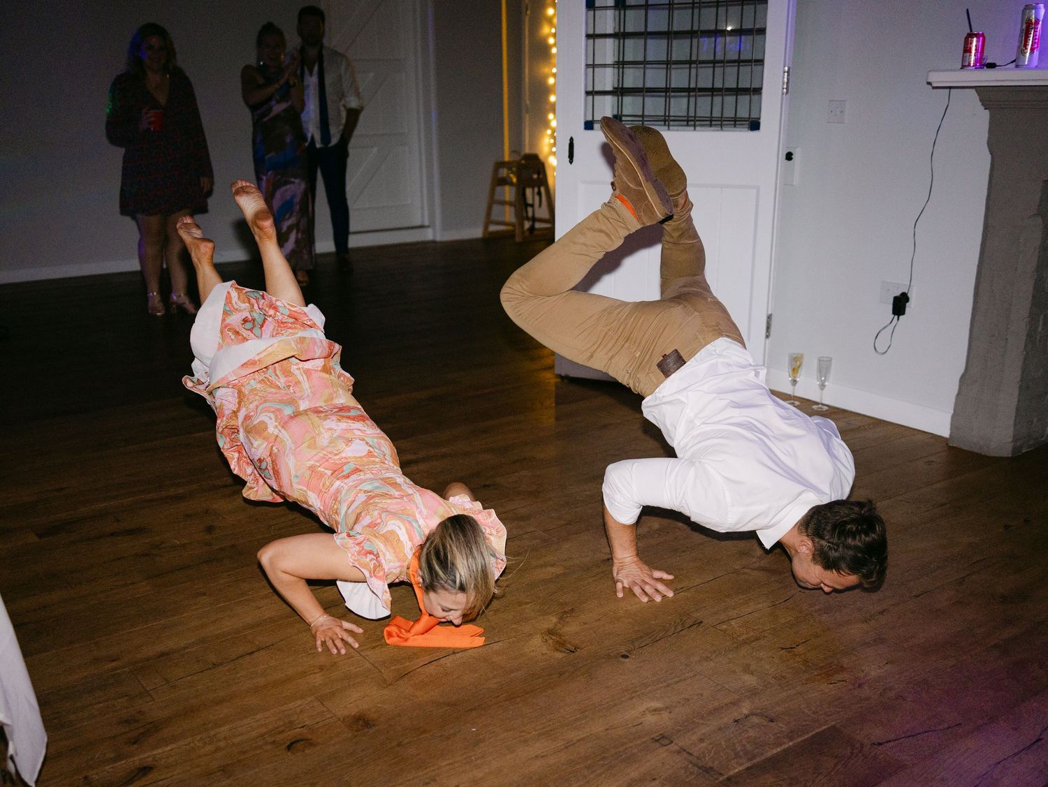 Party guests embrace and dance together during a joyful celebration.