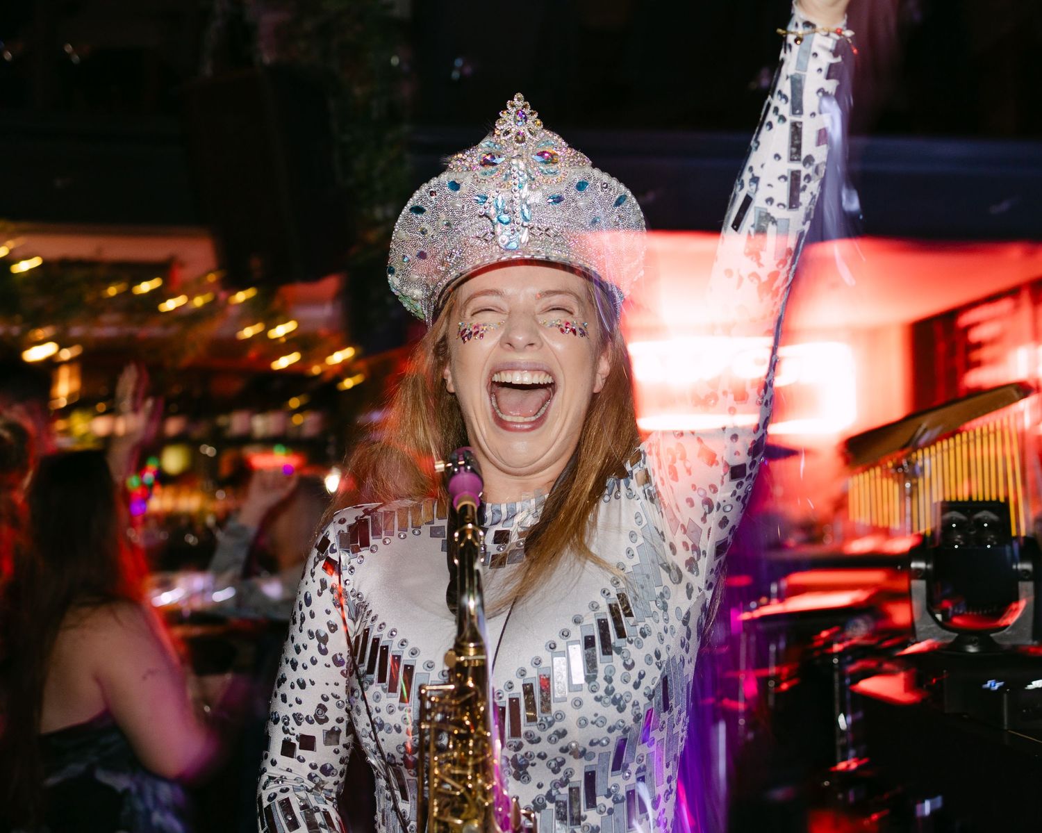Wedding party celebration with sparkly outfits and colorful lighting effects.