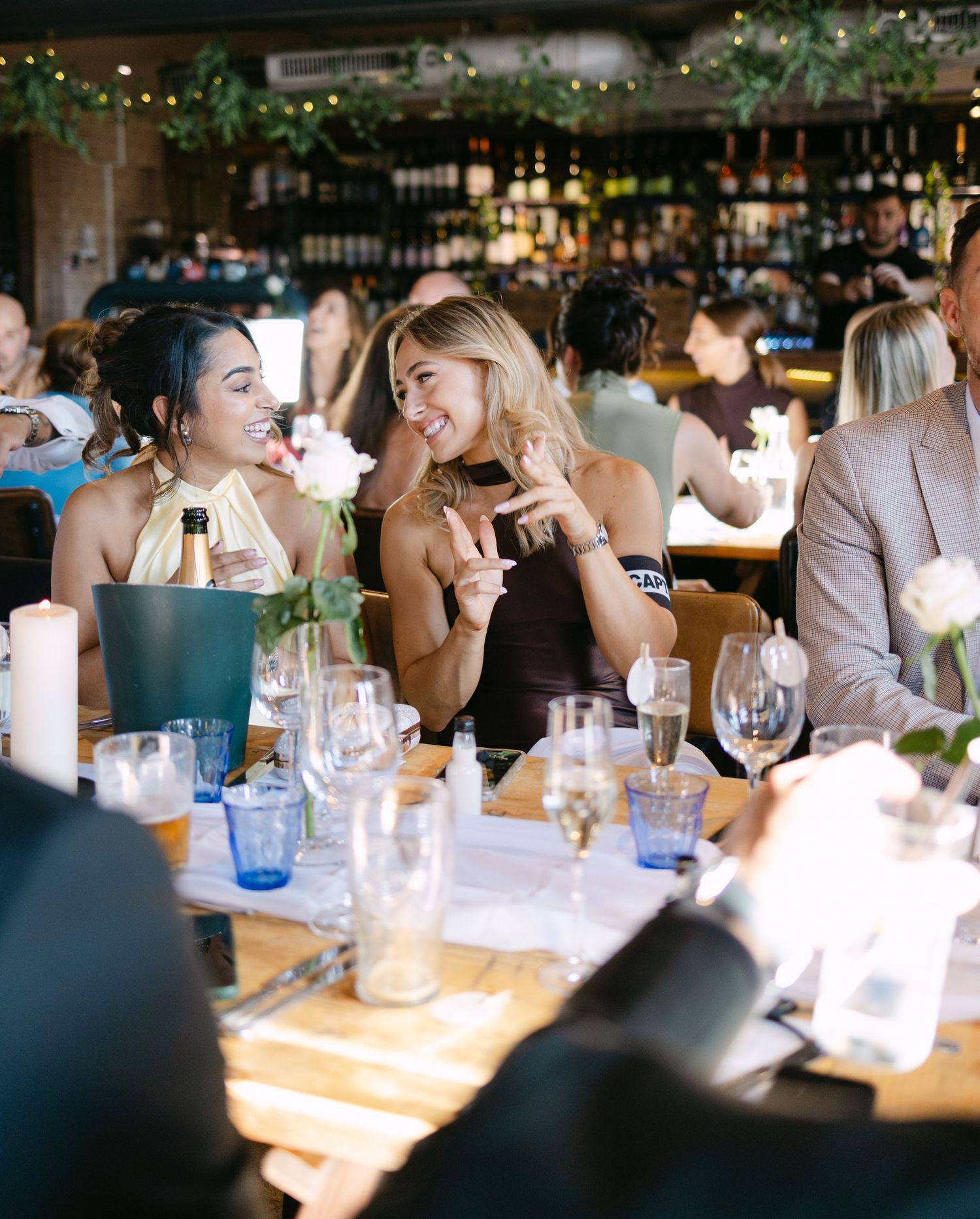 Guests share joyful moments during an elegant wedding reception at a restaurant.