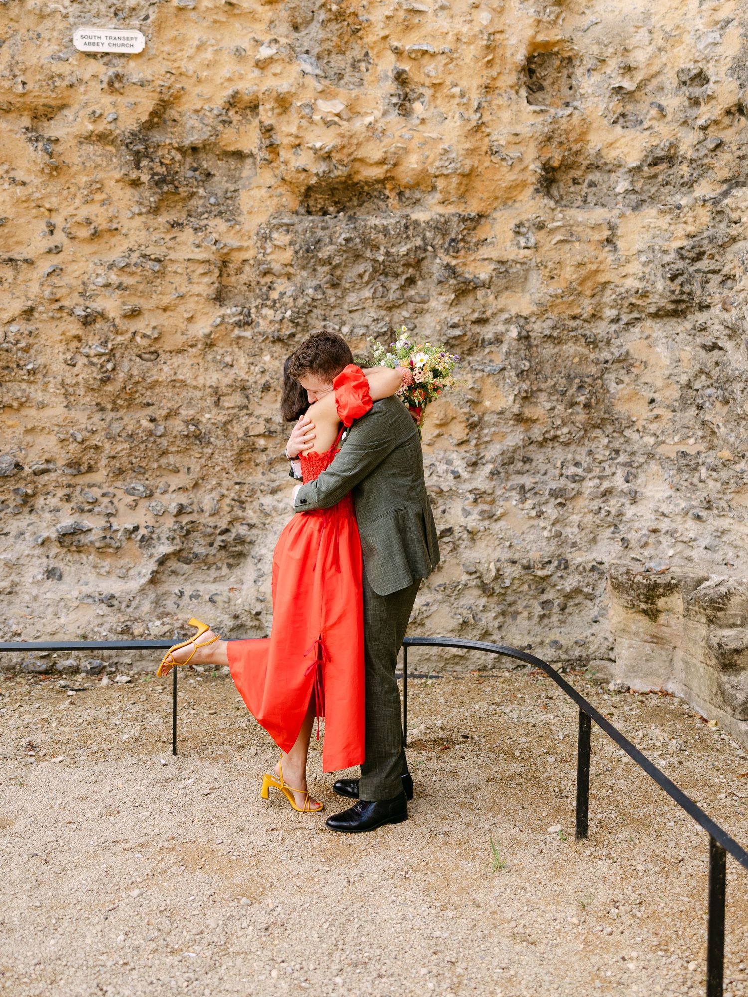 Wedding portraits taken at Reading Abbey Ruins with the bride in a red dress