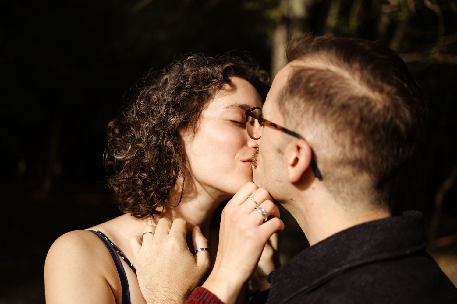 An intimate moment captured in dramatic shadows and lighting.