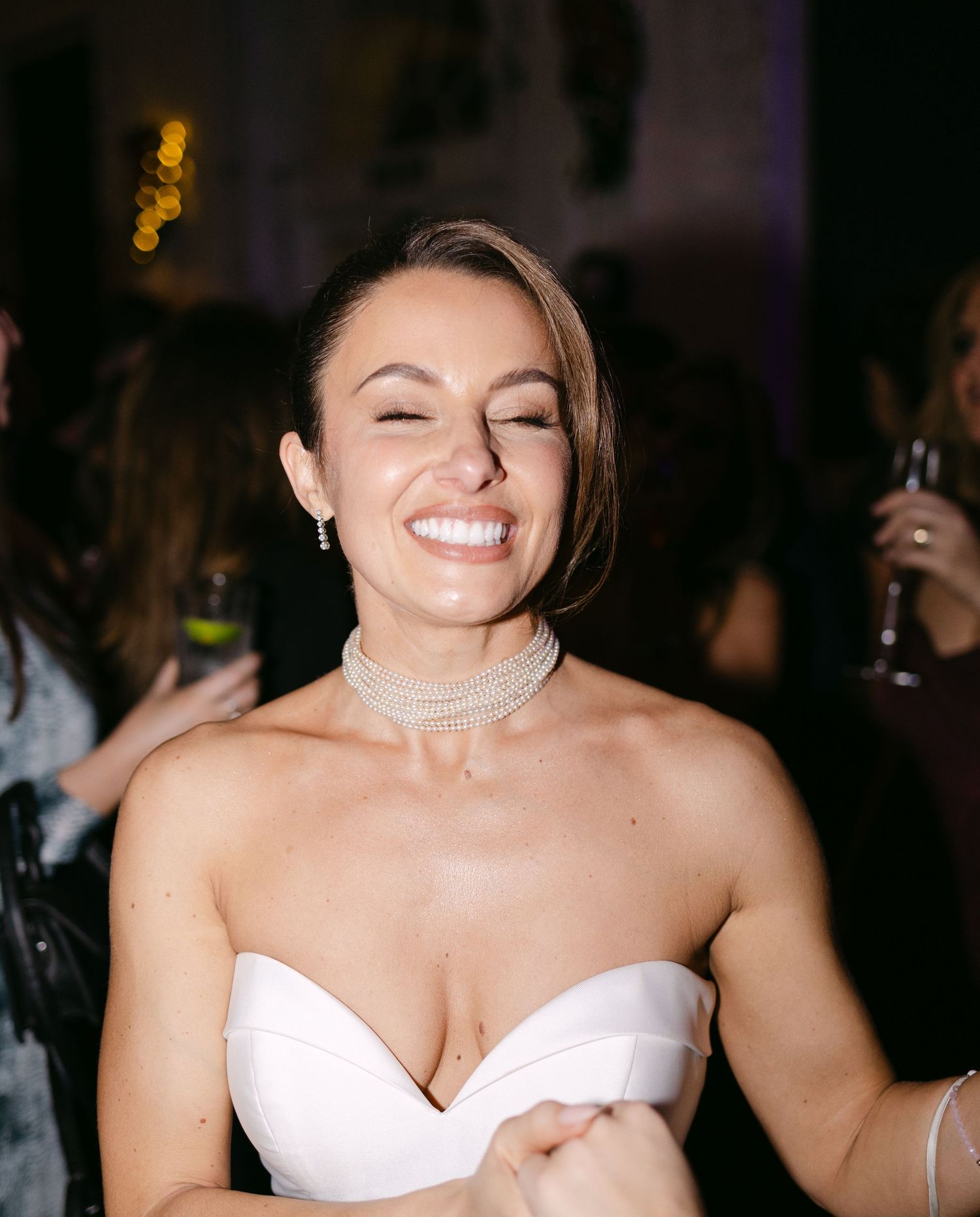 Candid sequence showing joyful expressions and laughter in a dark setting.