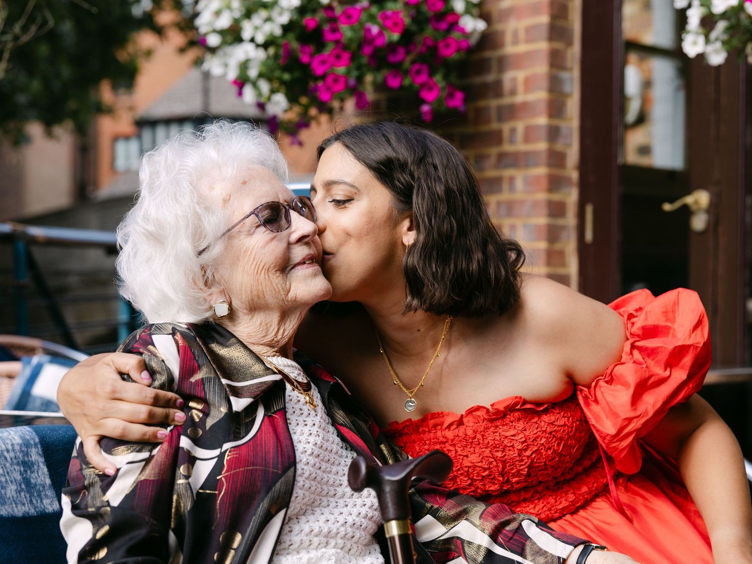 A warm celebration scene with people gathered at tables in a brick-walled venue.