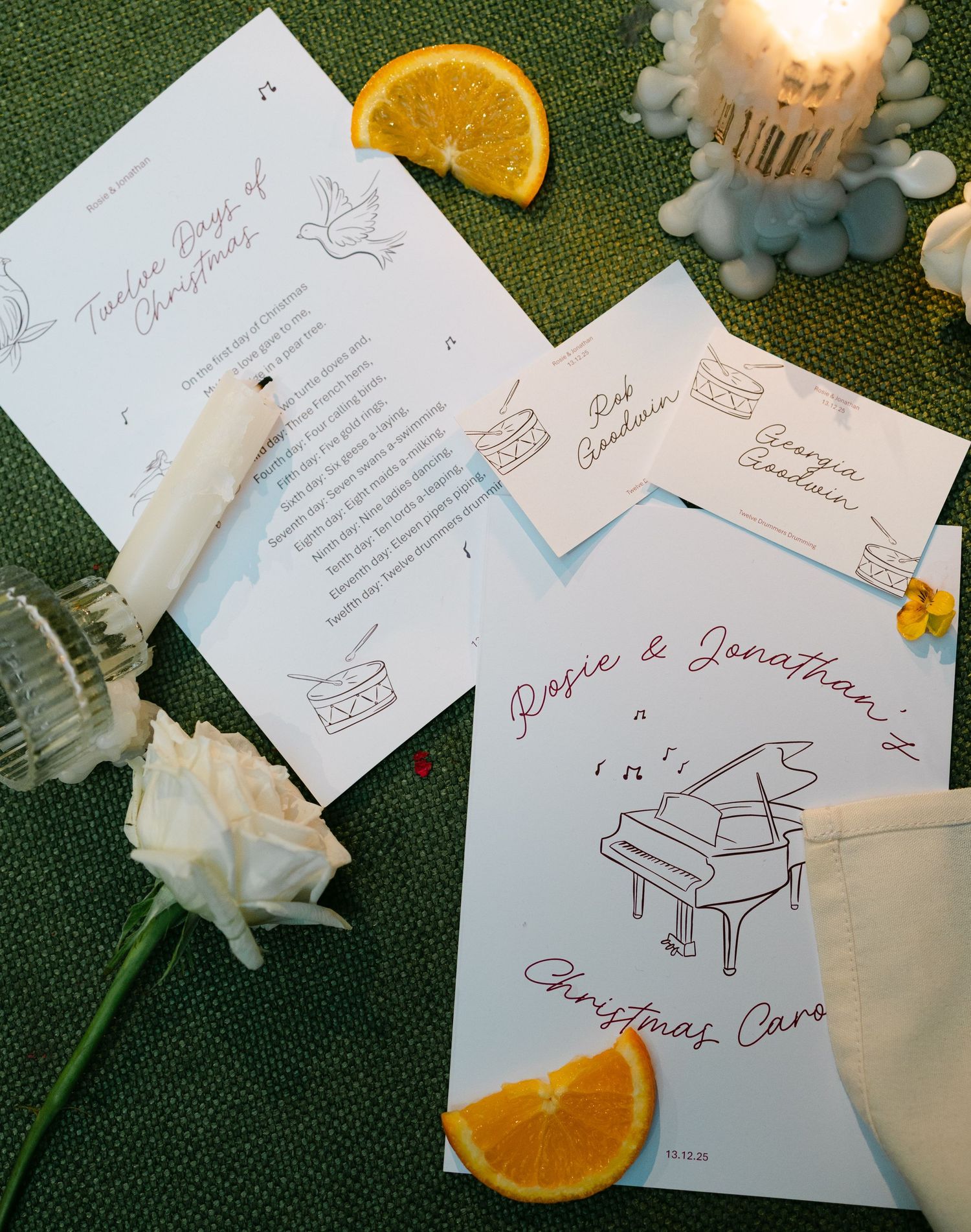 Wedding stationery featuring piano illustrations and orange slices as decorative elements.