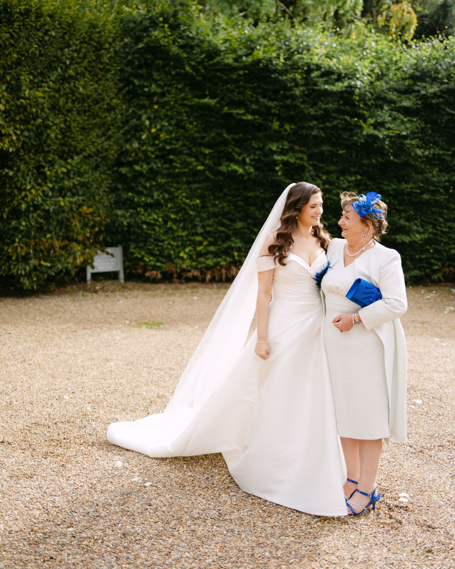 Couple in wedding attire sharing playful moments outdoors.