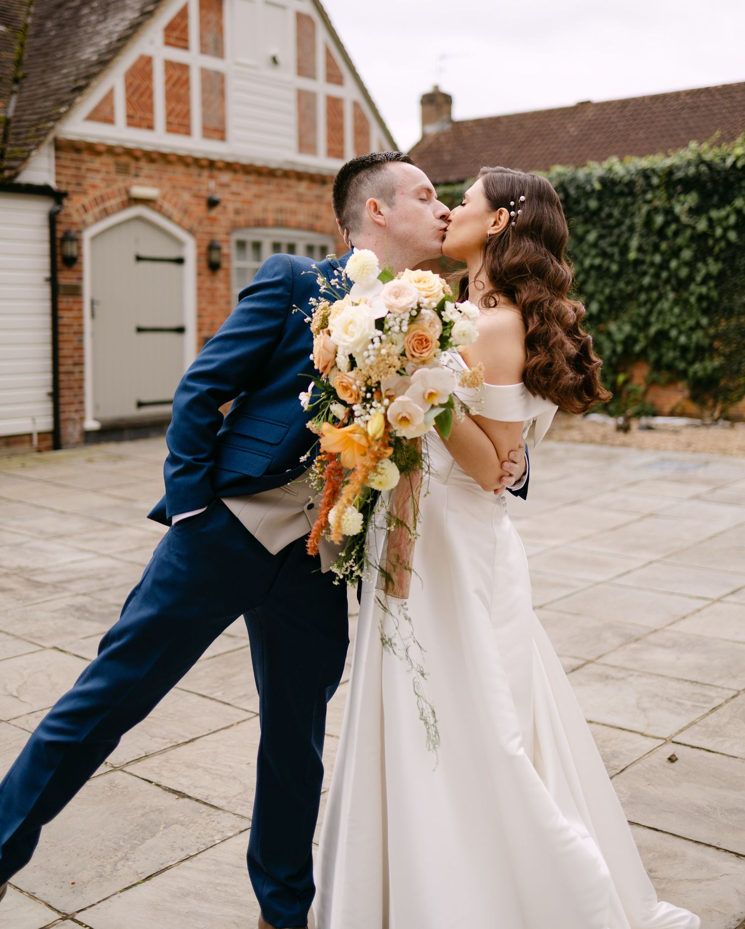 Romantic wedding sequence captured against a brick wall backdrop.