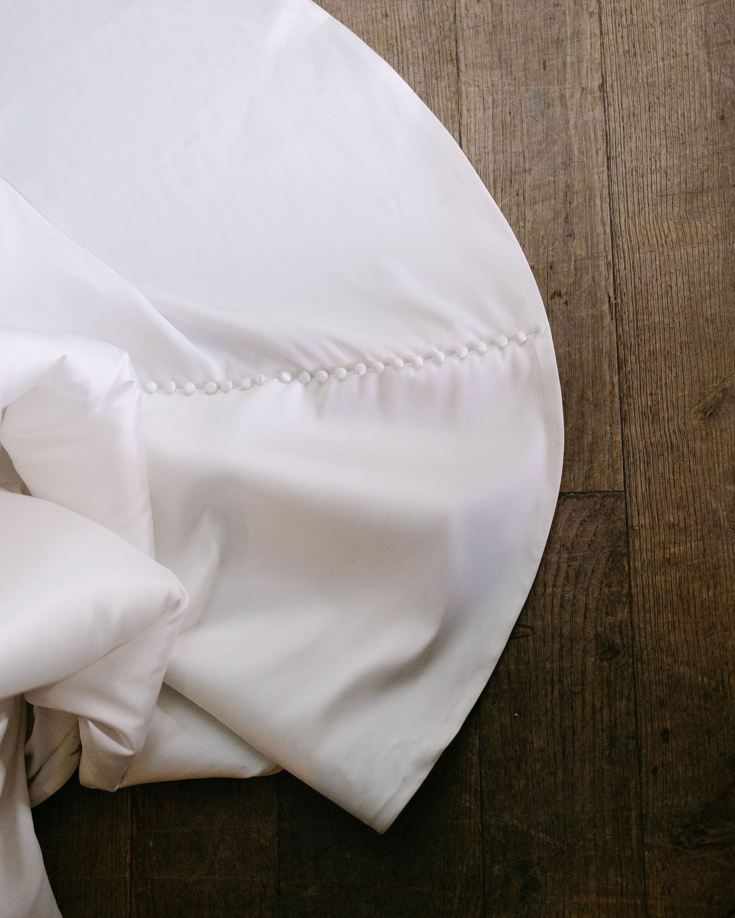 The train of a bridal gown, details caught at a wedding at Langshott Manor