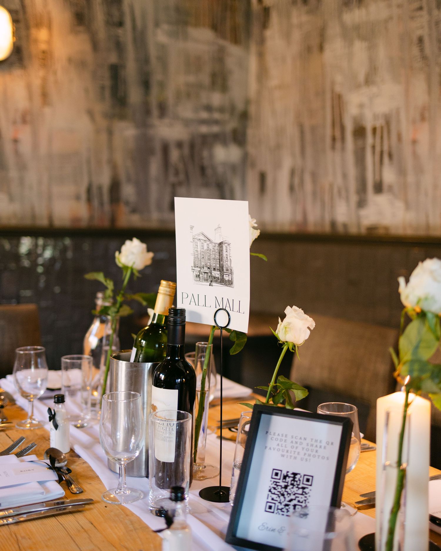Modern wedding reception table with QR codes and digital displays among traditional decorations.