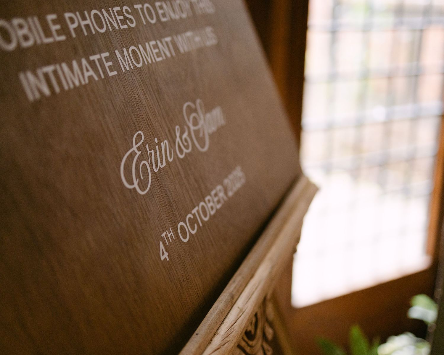 Rustic wooden sign board with text displayed at wedding venue.